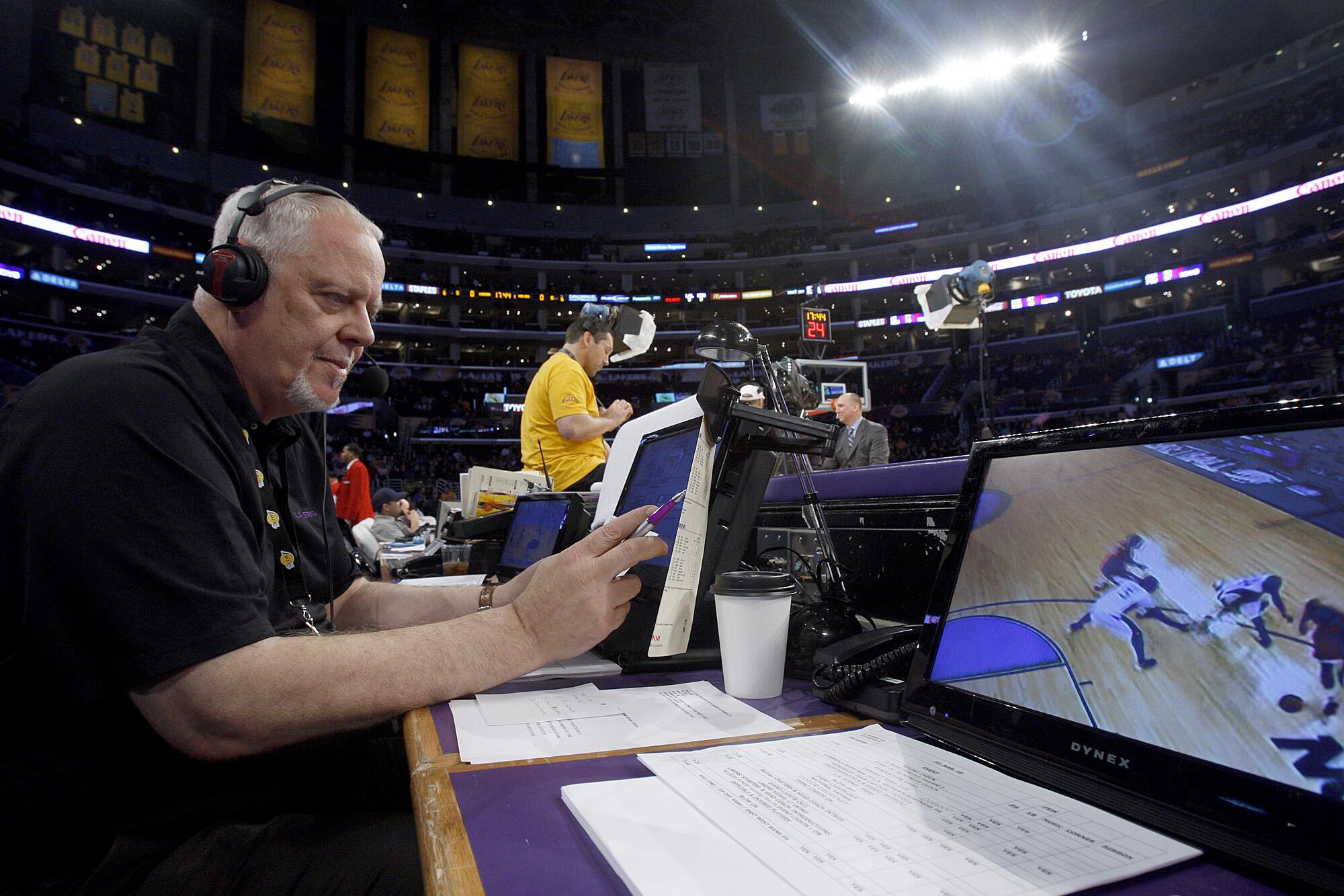 Lakers public address announcer Lawrence Tanter gets set up at the scorer's table before a game in 2011.