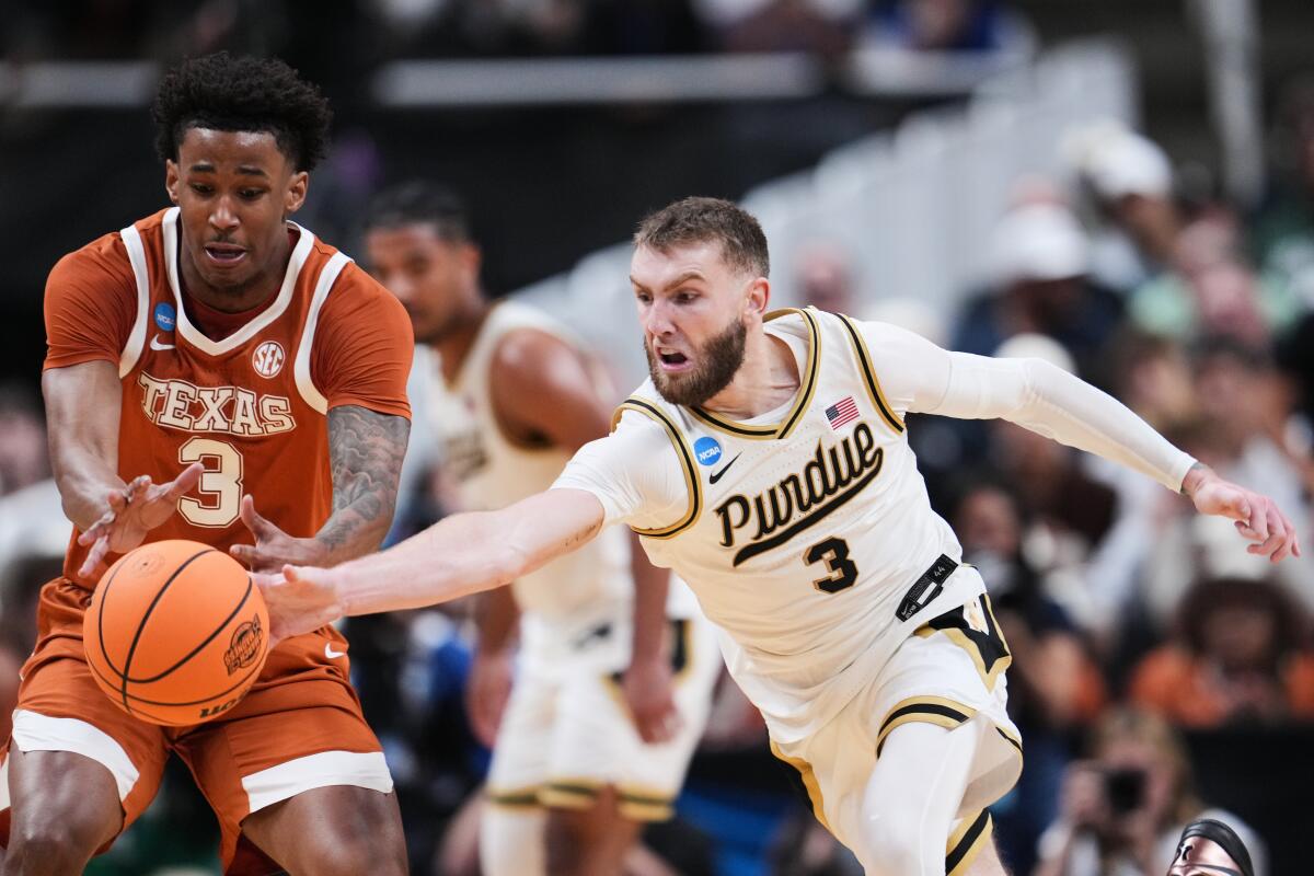 Texas forward Dailyn Swain, left, vies for a loose ball against Purdue guard Braden Smith during an NCAA tournament game.