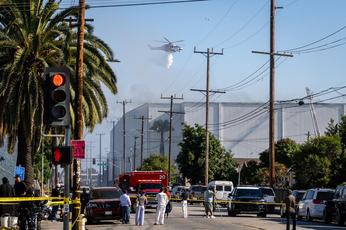 Emergency crews drop water on a warehouse fire in Los Angeles' Boyle Heights neighborhood.