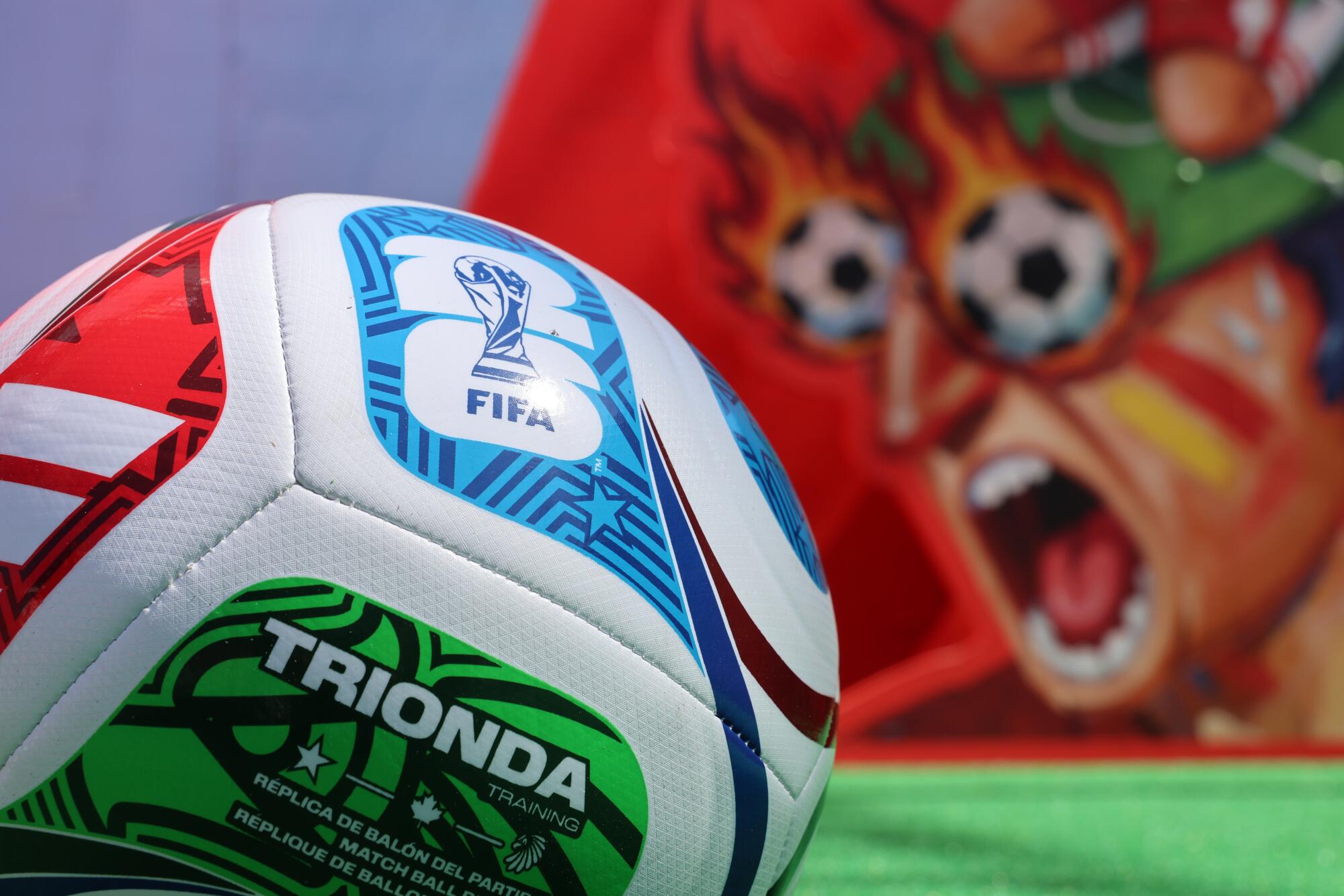 A view of a soccer ball featuring the FIFA World Cup logo and graphics at the DoorDash booth.