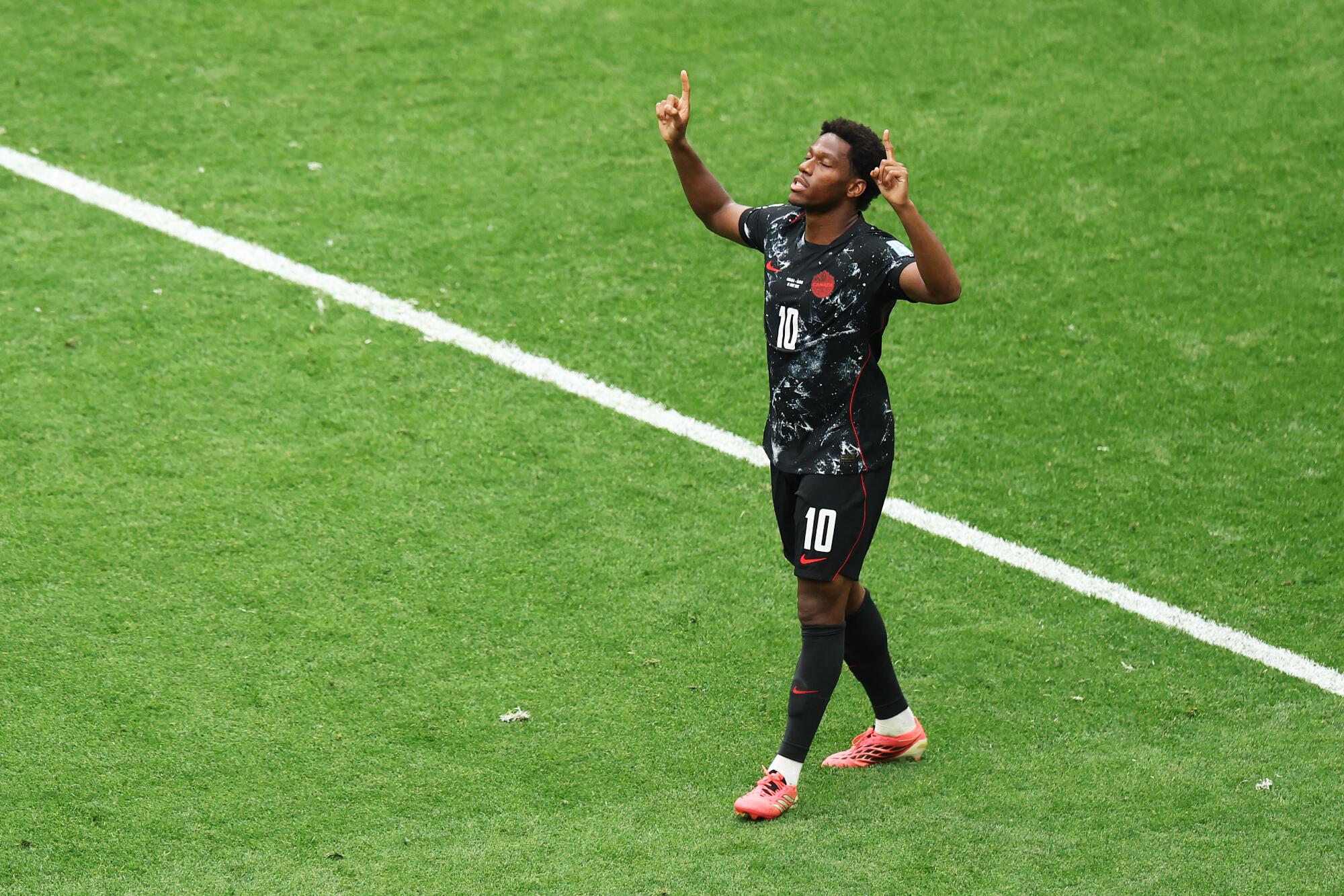 Canada's Jonathan David celebrates after scoring one of three goals during a 6-0 win over Qatar.