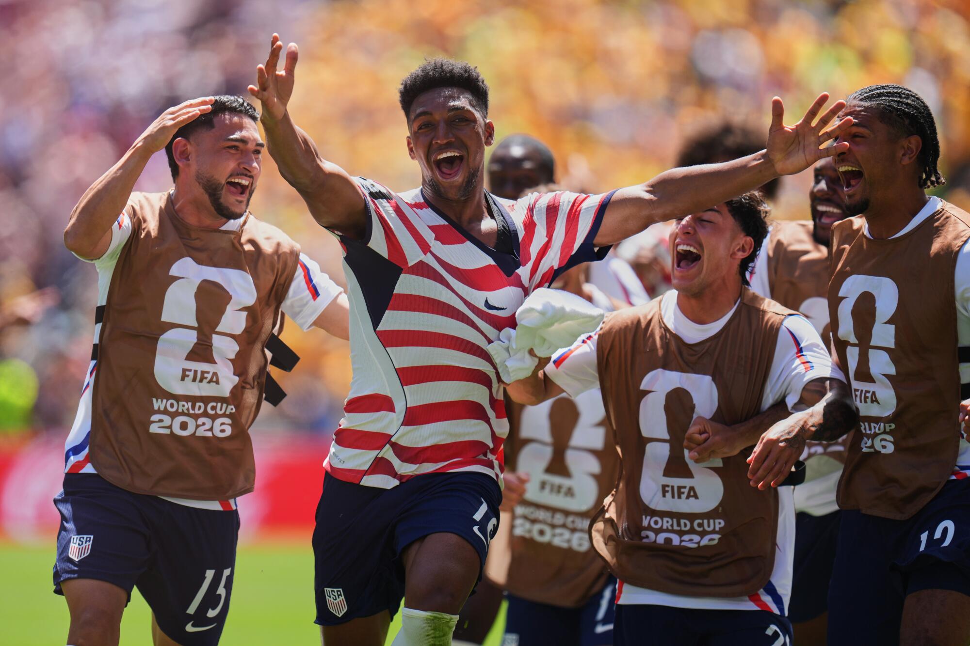 U.S. defender Alex Freeman (16) celebrates with teammates after scoring in a 2-0 win over Australia.