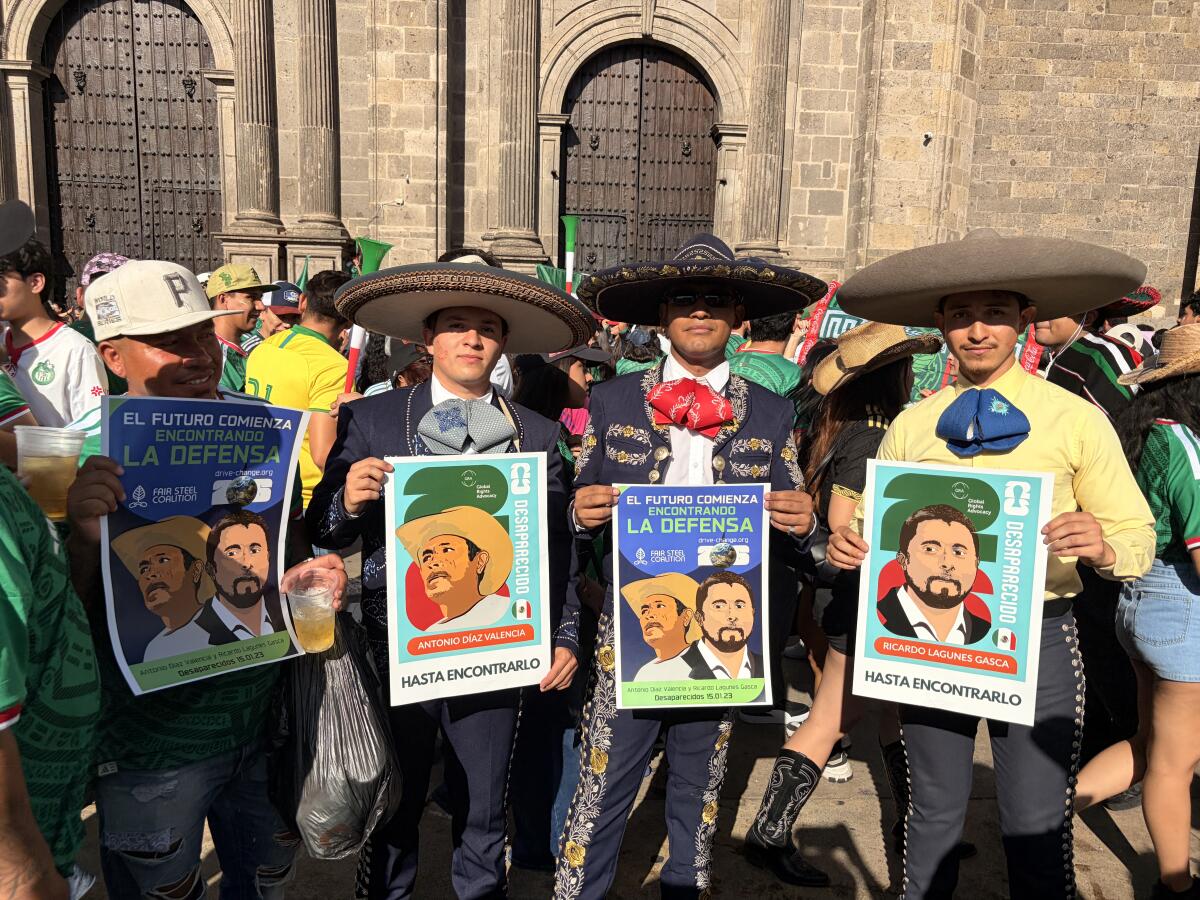 Mariachis hold posters commemorating the disappearance of two environmental activists in Guadalajara