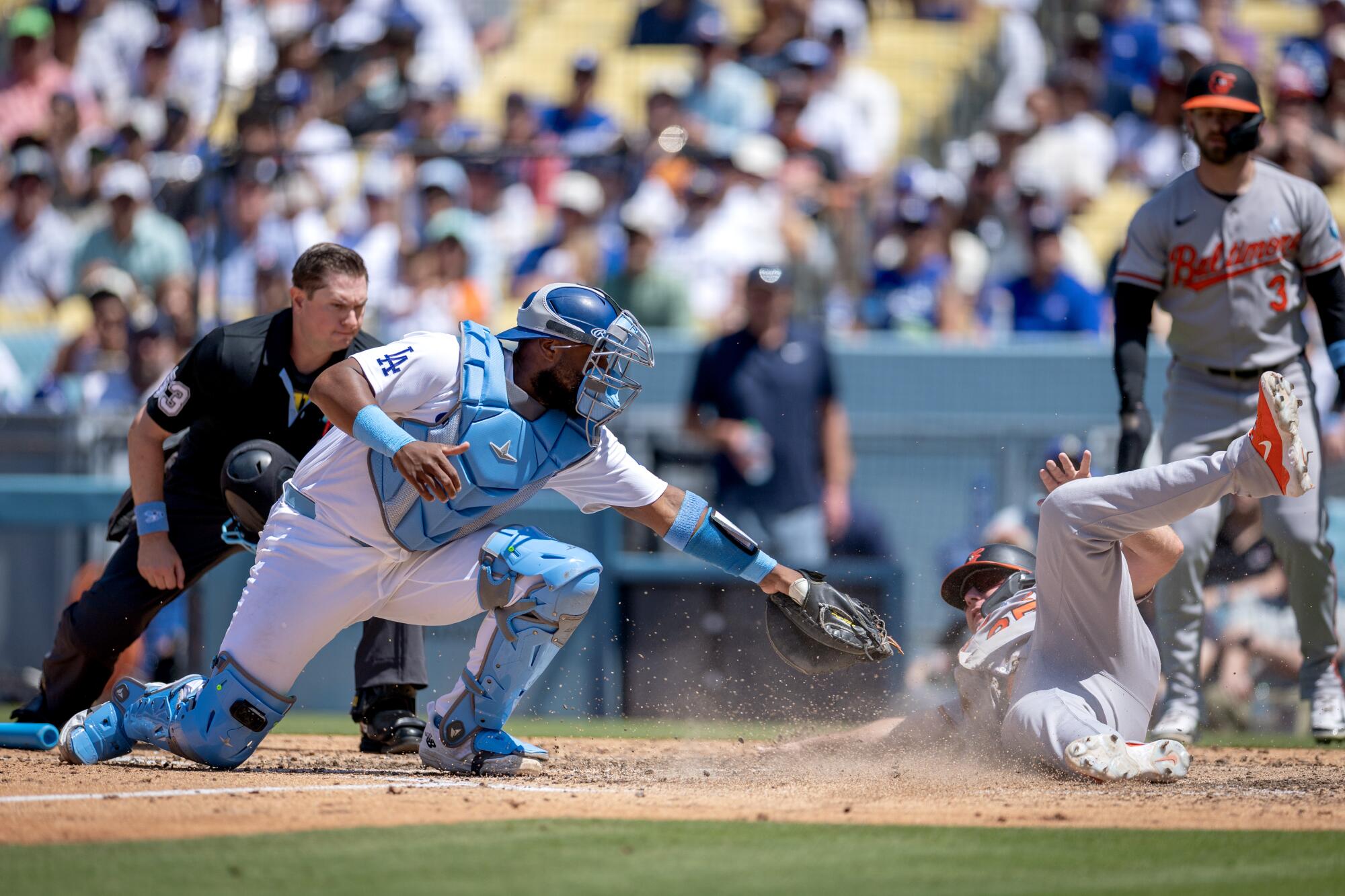 Baltimore's Pete Alonso scores after beating a throw to Dodgers catcher Chuckie Robinson.