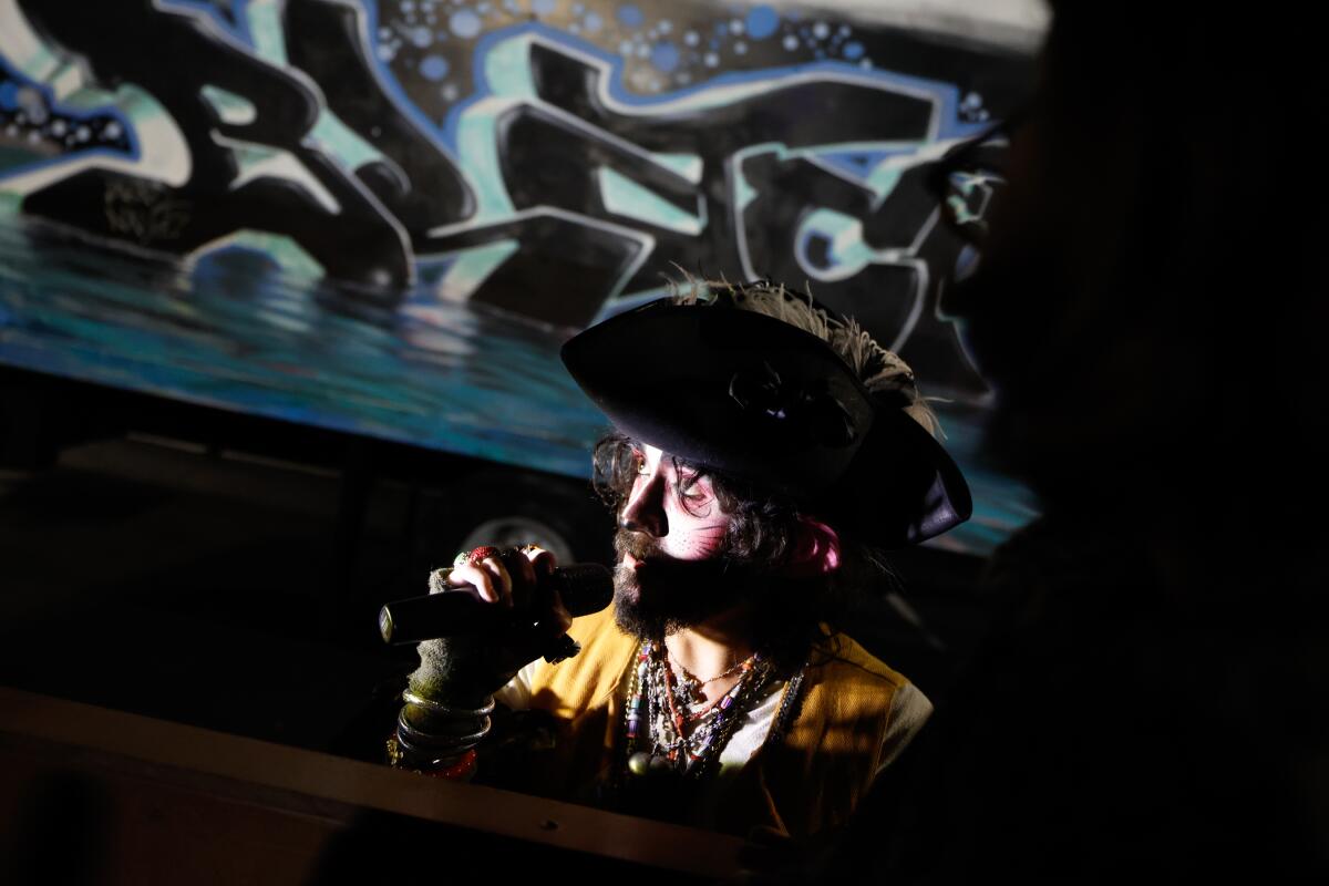 A man with a pirate hat speaks into a microphone. 