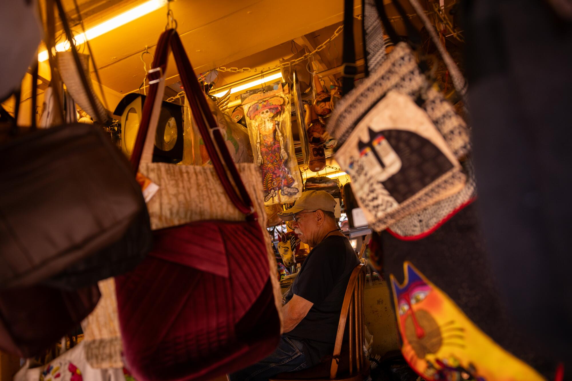 Olvera Street stand owner, Rene Gutierrez, in his business. His father opened the stand in 1929.