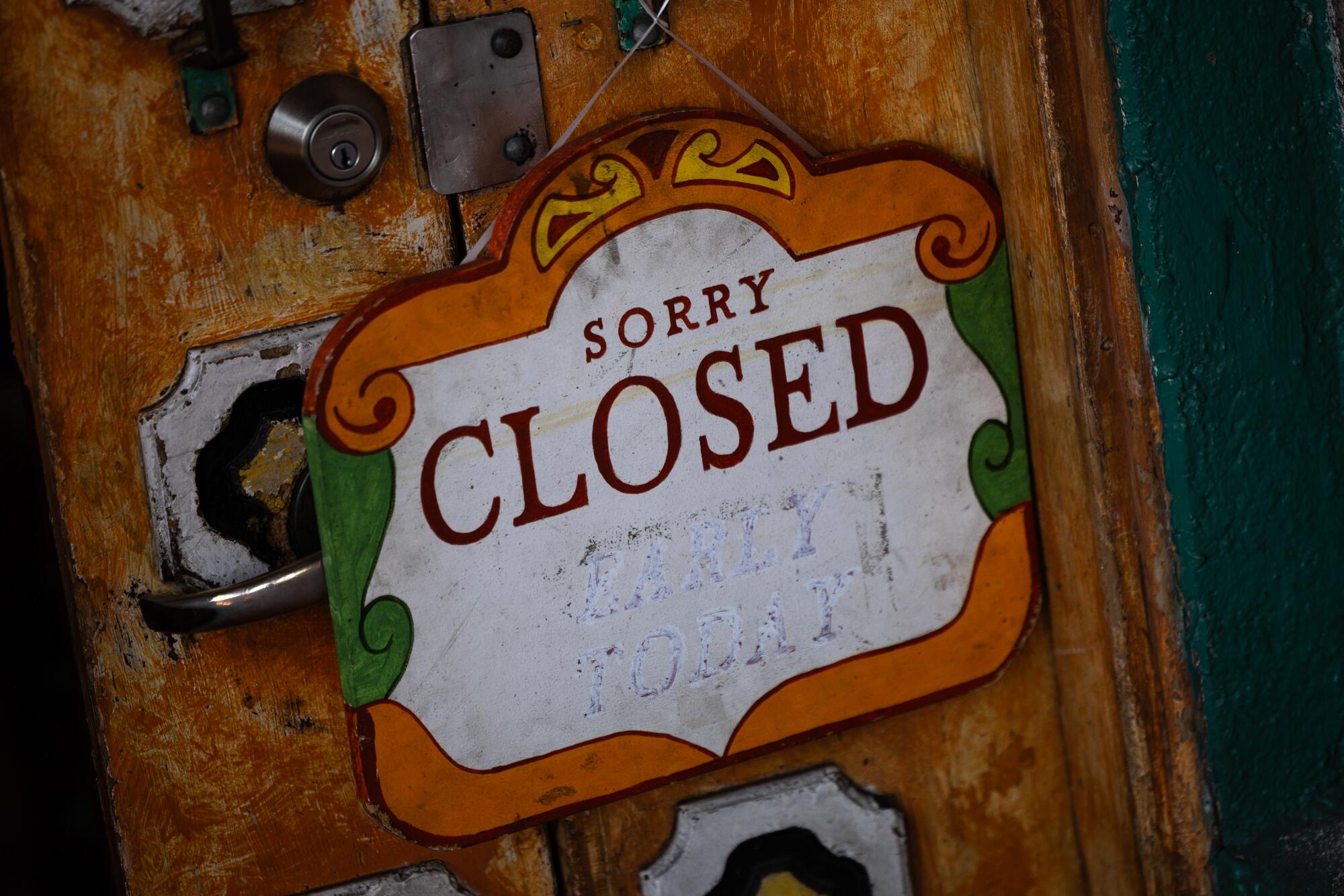 A closed sign on the door of Las Anitas on Olvera Street.