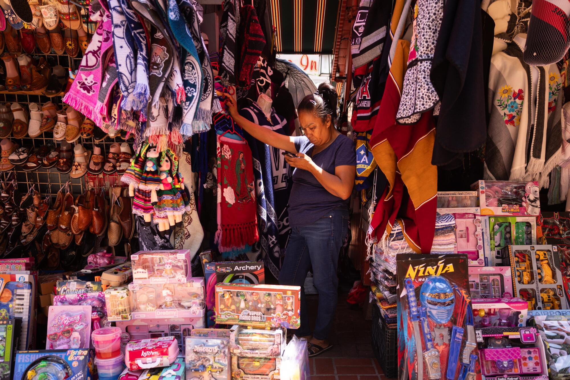 A stand clerk waits for customers on Olvera Street.
