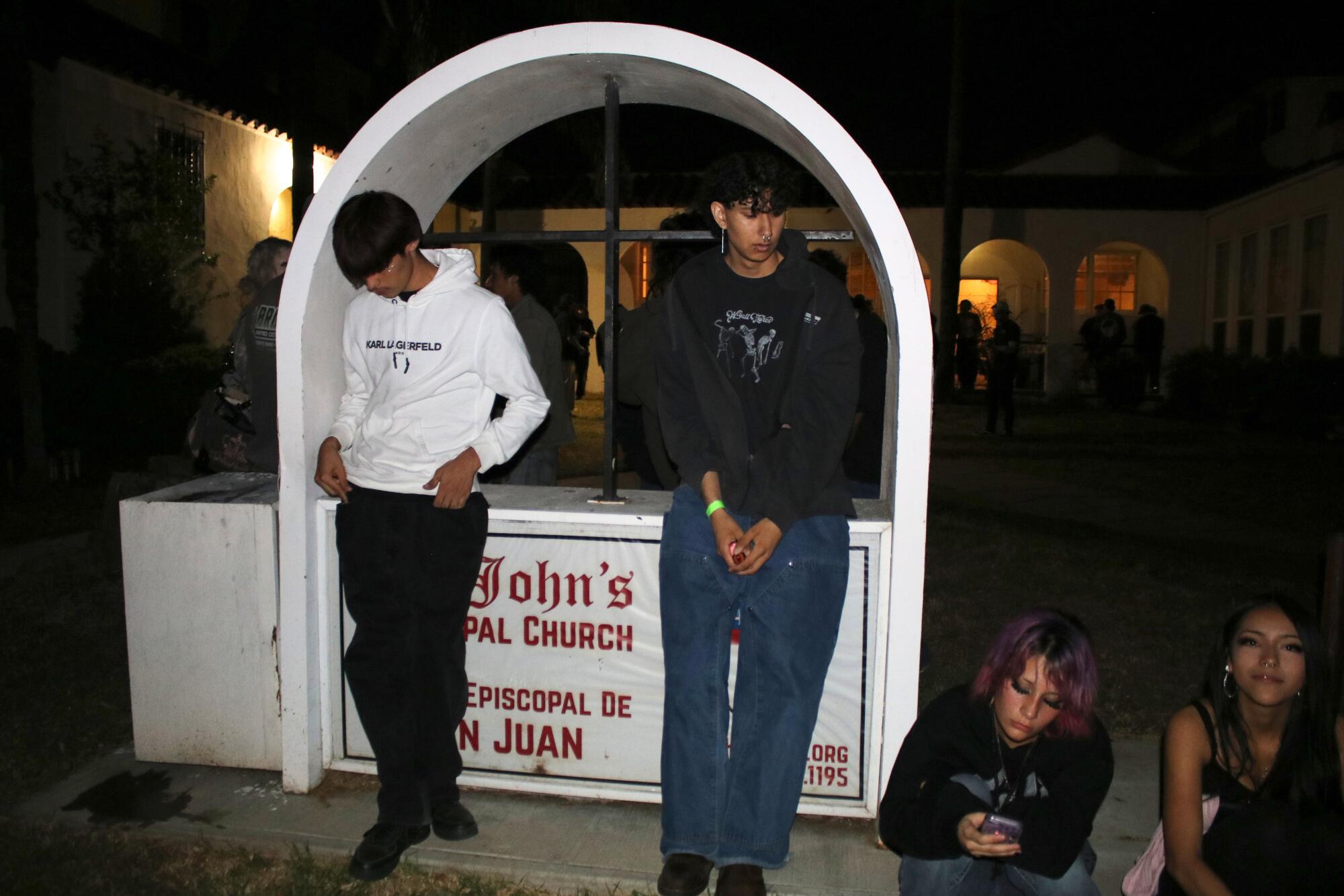 Teenagers congregate in front of St. John’s Episcopal Church