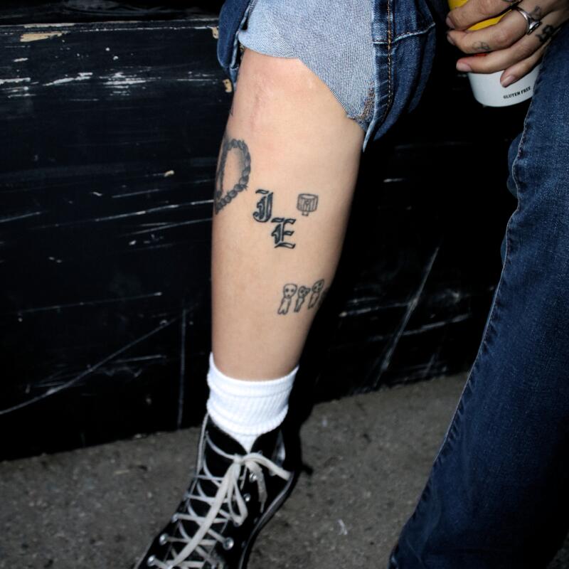 Toni Feliz shows her "IE" tattoo, a nod to her hometown, at Creator Fest on May 2, 2026, at Creator Tattoo in Pomona.