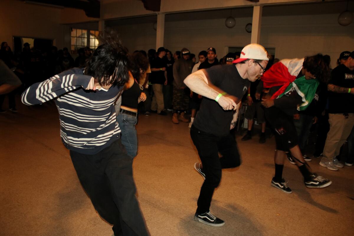 Fans dance and "two-step" during Barrio Slam's performance on April 3, 2026, in St. John's Episcopal Church in San Bernardino.