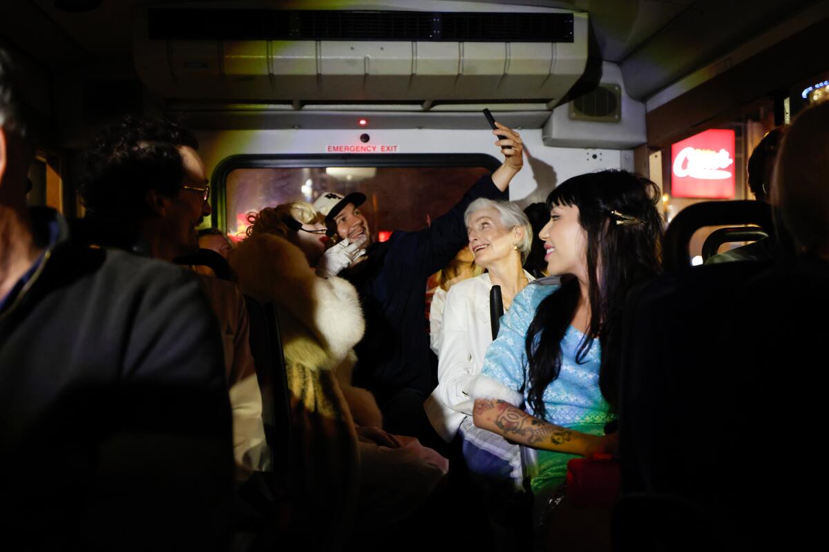 Riders sit in a dark bus.