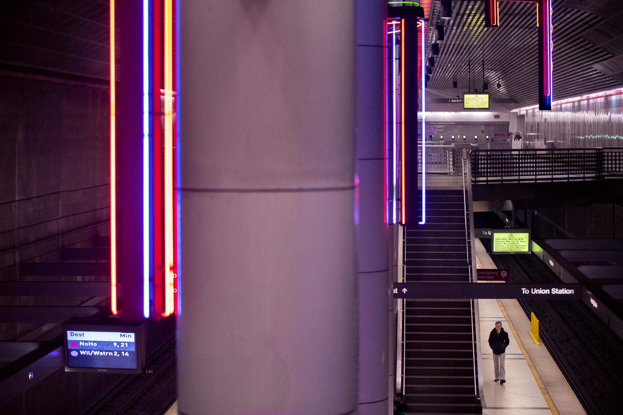 A man waits for a train at the Wilshire/Vermont station in Los Angeles, Calif.
