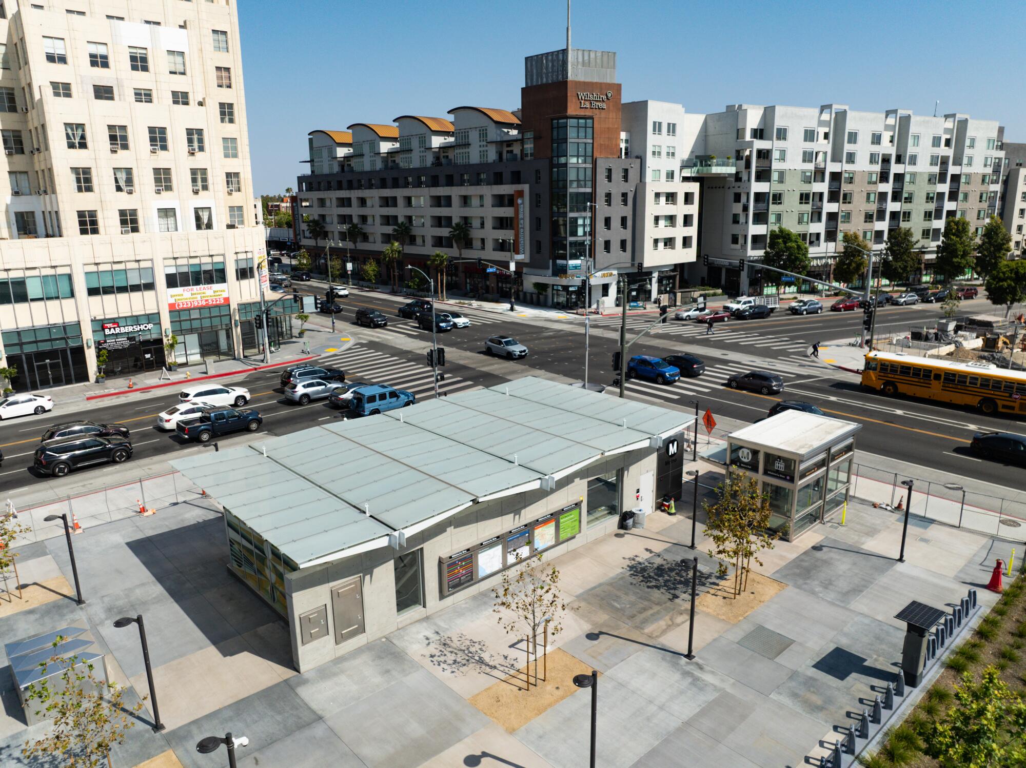 Pedestrians walk past the Metro D Line at Wilshire and LaBrea.