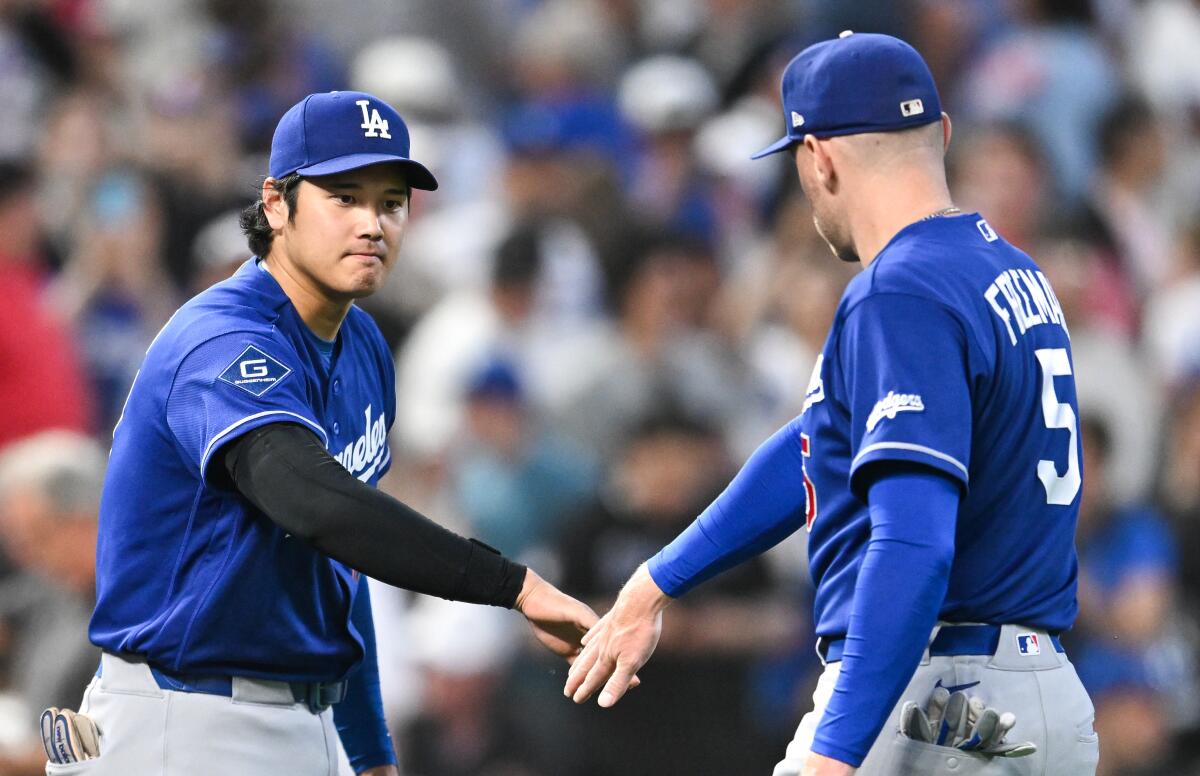 Shohei Ohtani and Freddie Freeman celebrate Monday's win over the Twins.
