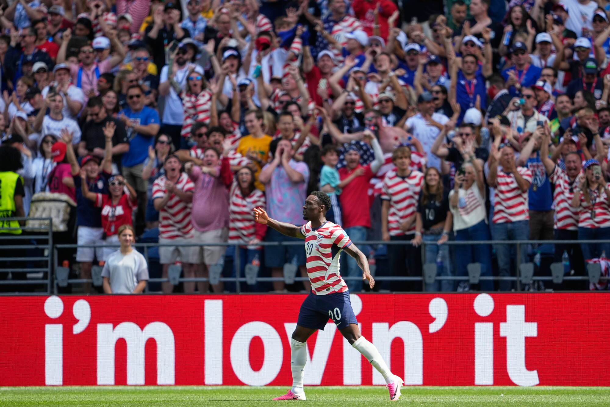United States' Folarin Balogun celebrates the team's first goal with fans.