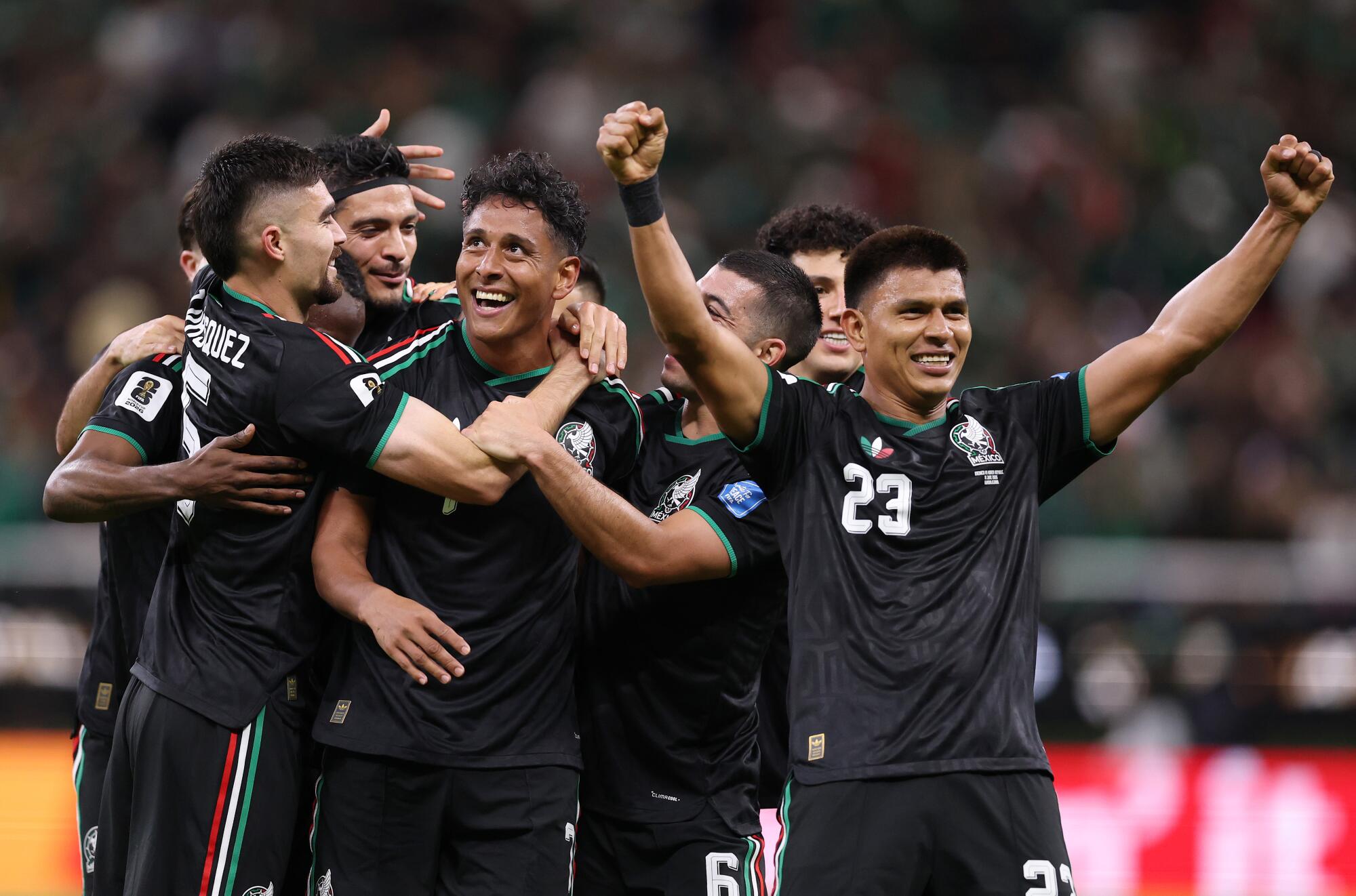 Mexico's Luis Romo, center looking up, celebrates with teammates after scoring against South Korea on June 18.