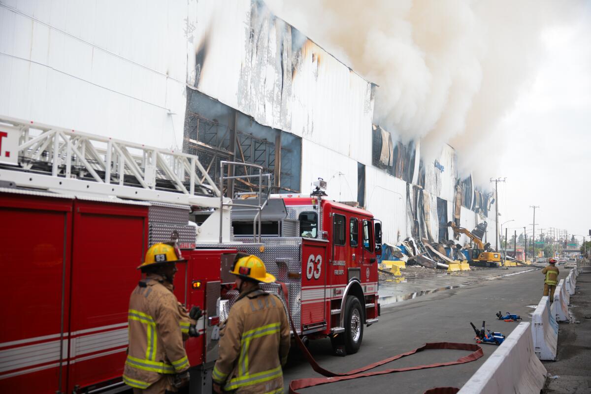 Smoke smolders from the Lineage cold storage facility