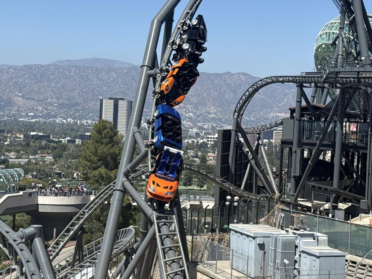 Rotating coaster cars coming down from a loop.