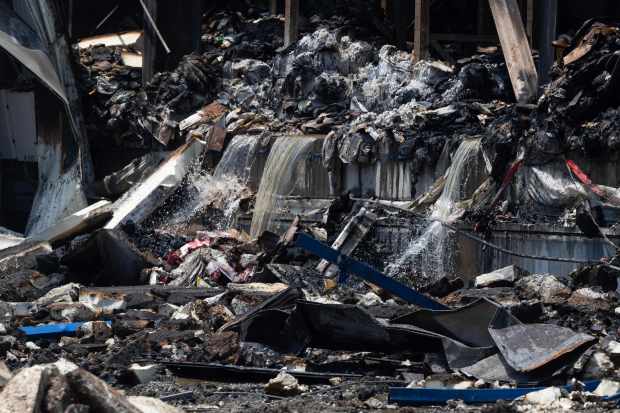 Water drains from the smouldering remains of a massive cold storage facility fire in Boyle Heights on Tuesday, June 23, 2026. (Photo by Drew A. Kelley, Press-Telegram/SCNG)