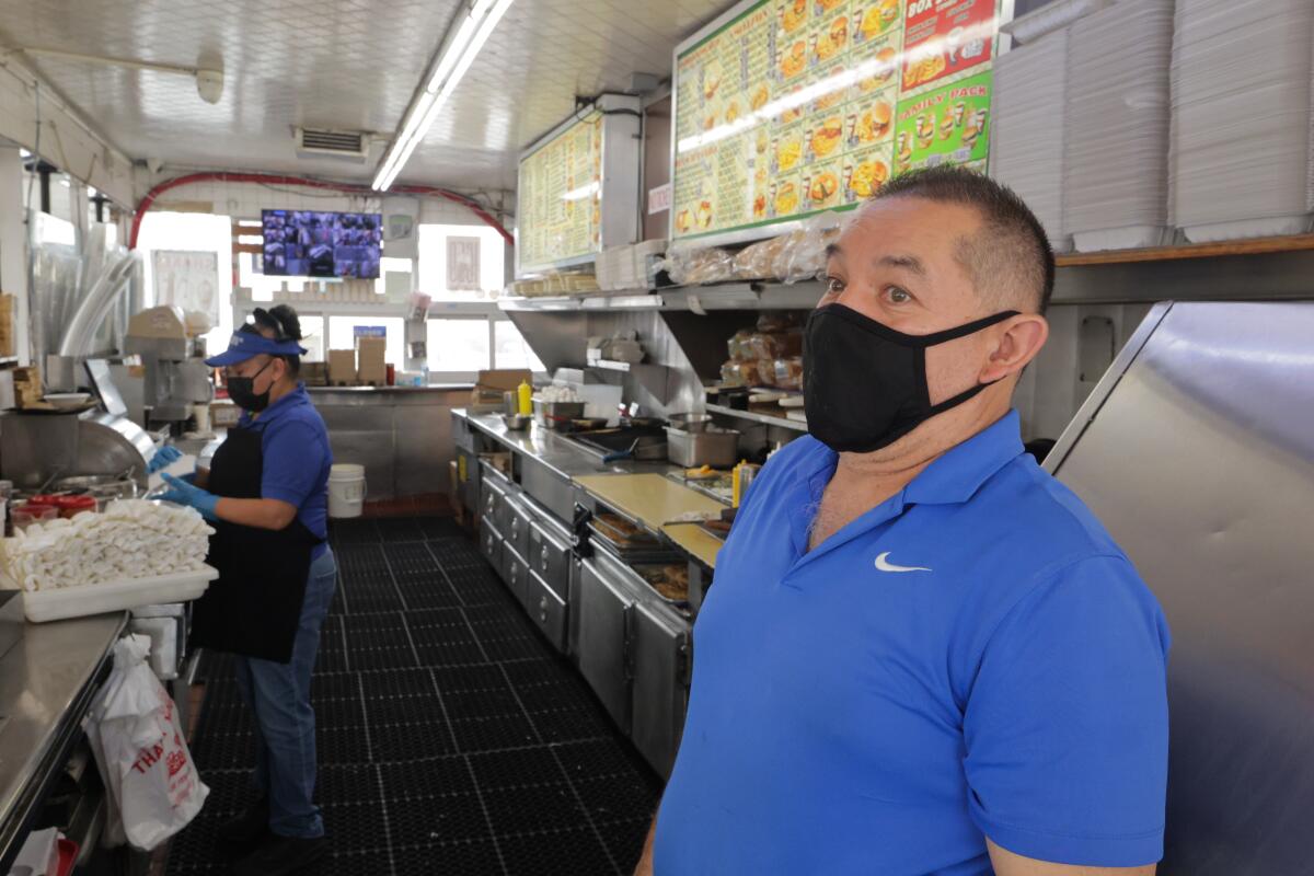 A man in a restaurant wearing blue.
