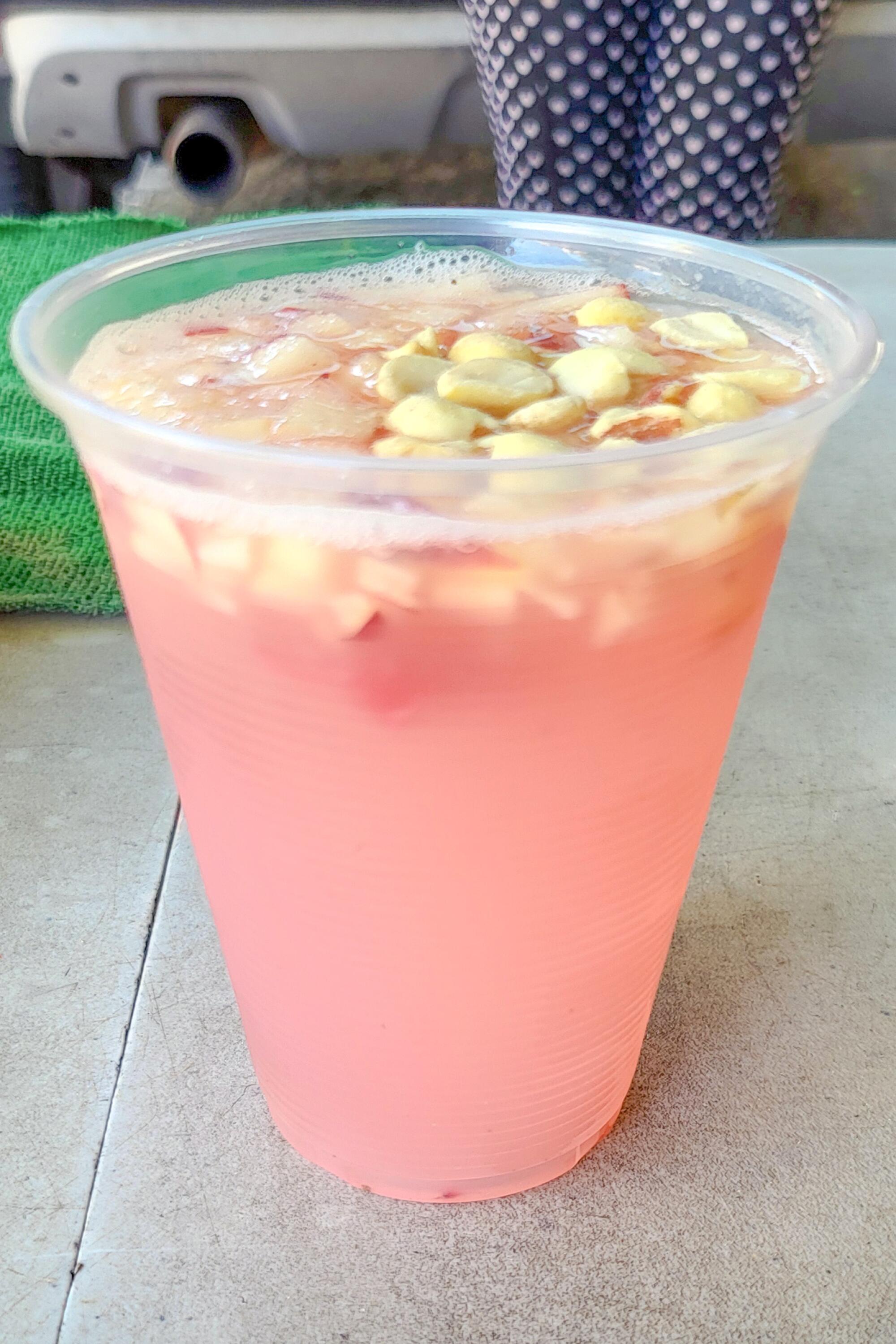 Glass of tuba compuesta, a fermented drink made from the sap of the coconut palm.
