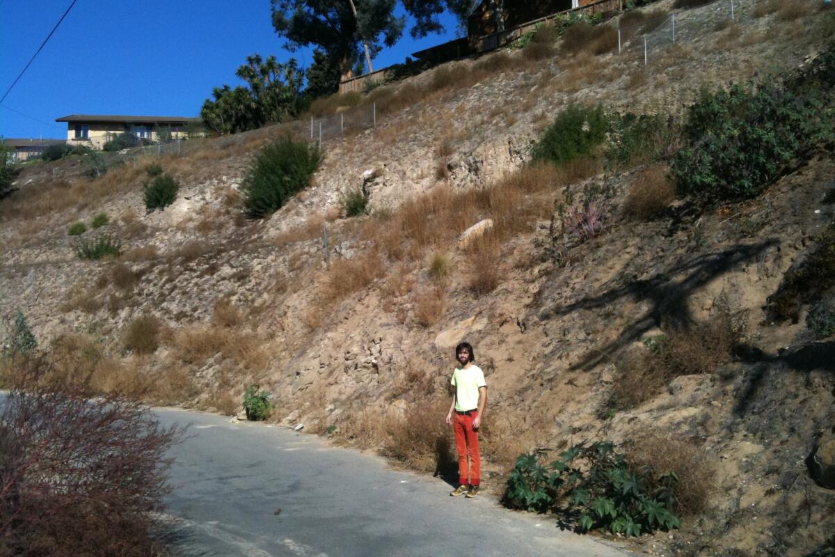 Diego Cano-Lasso stands in front of the hillside lots in 2012.
