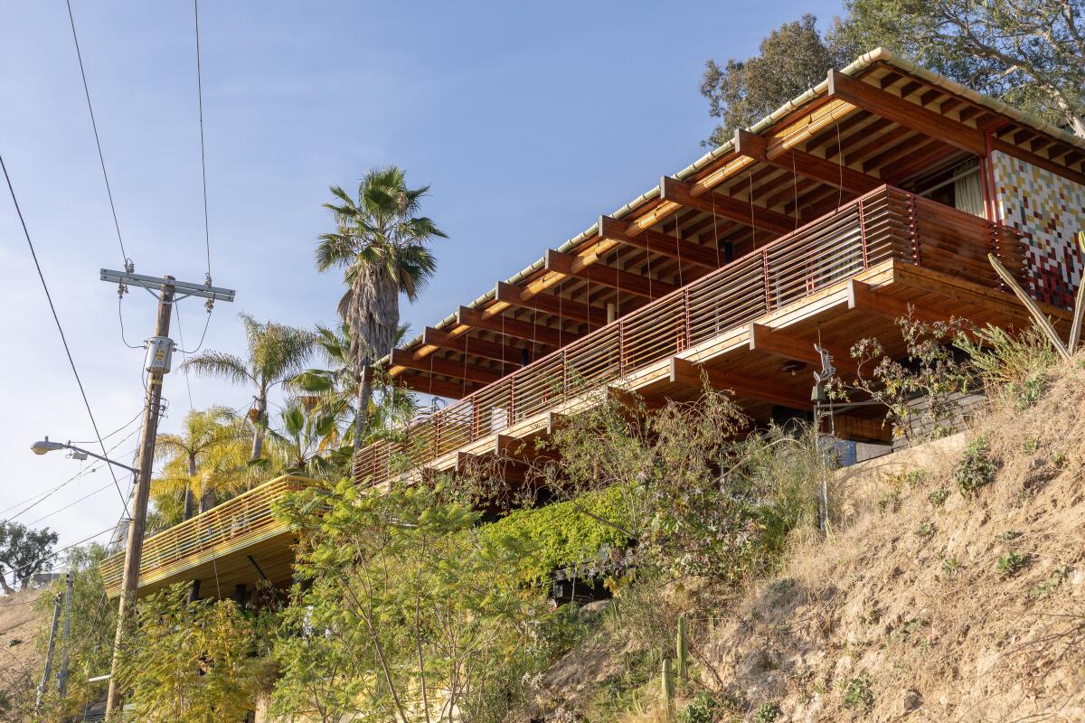 Two midcentury-style houses side by side on a hillside.