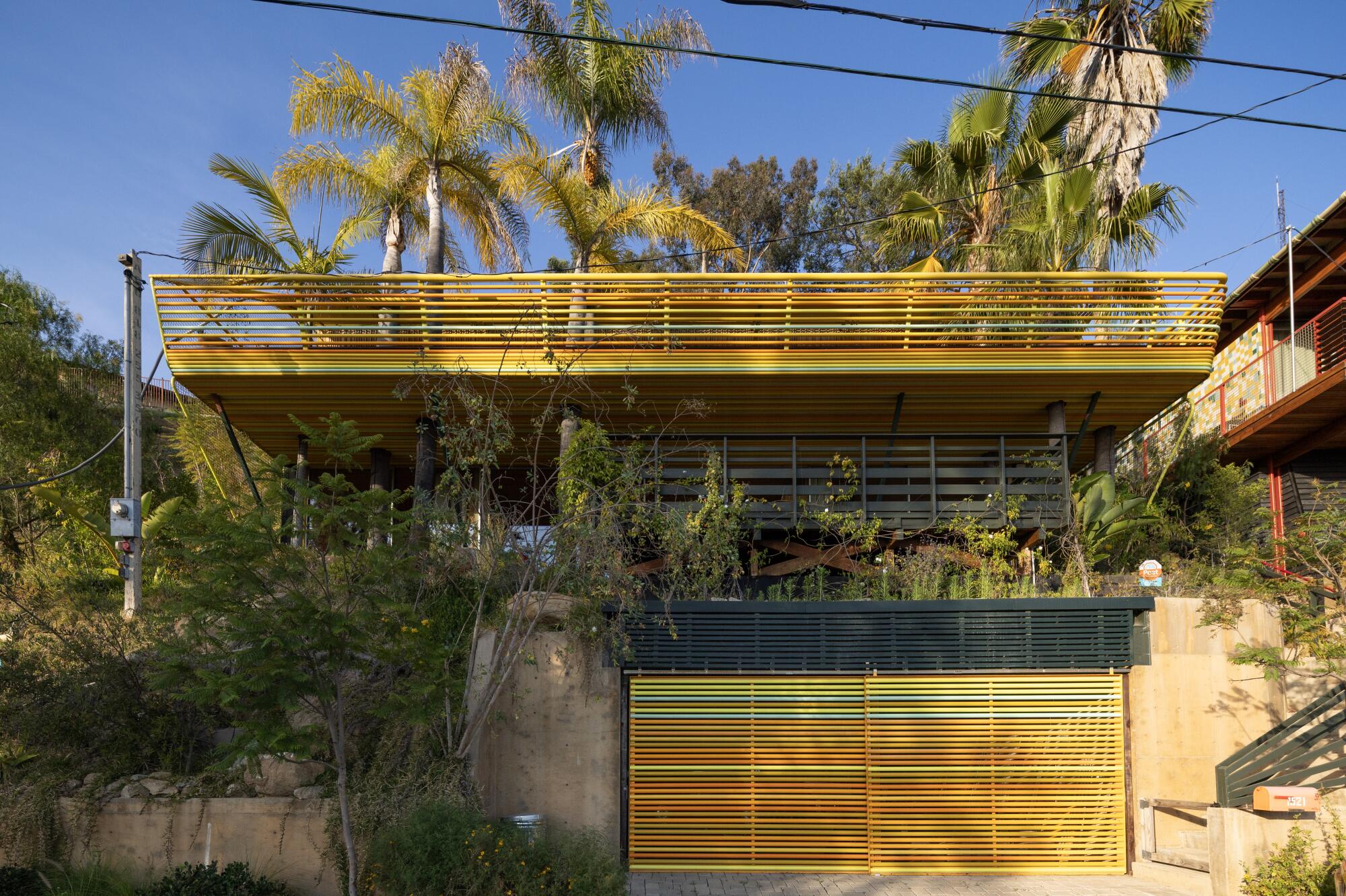 A brightly colored house with aluminum tubes.