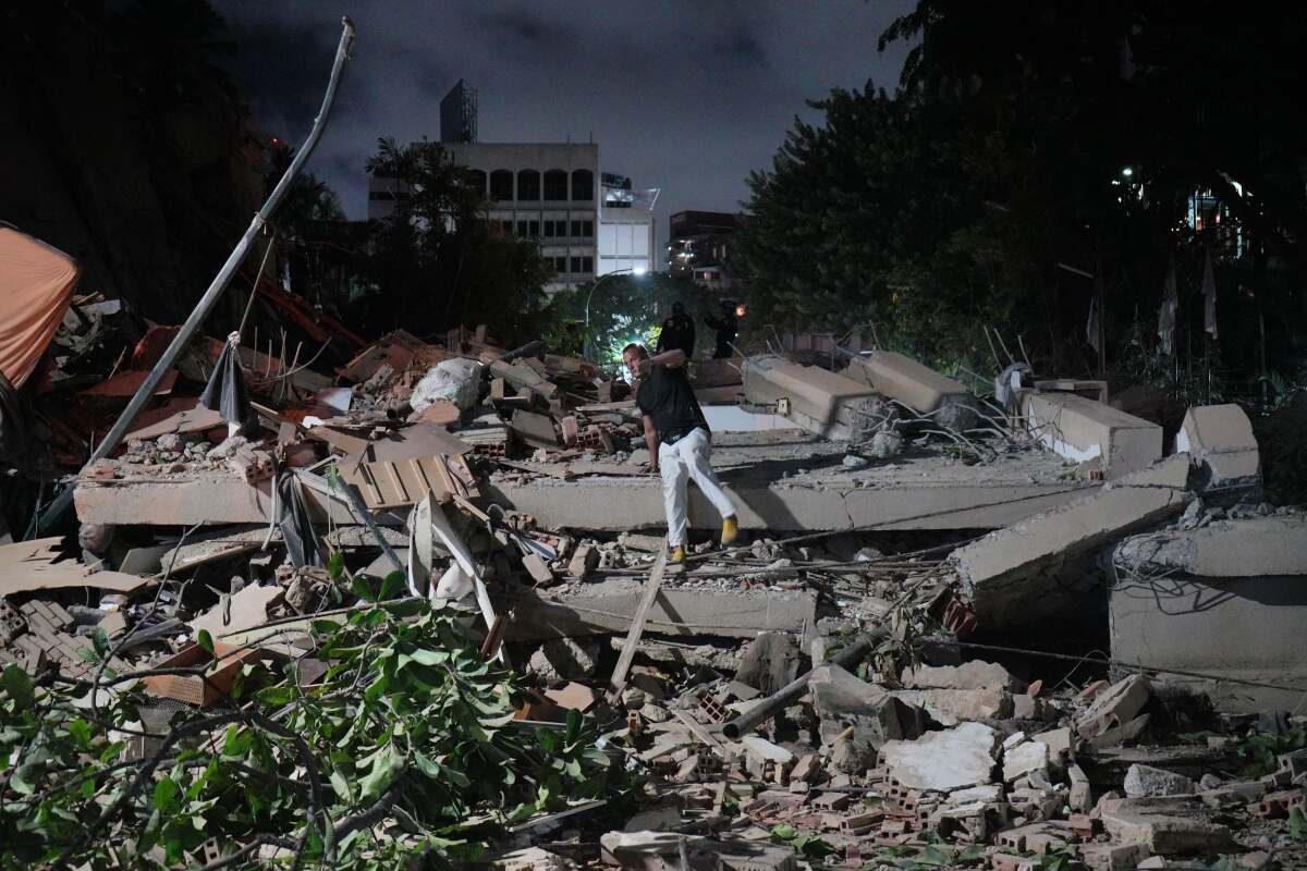 A man jumps on a collapsed building after an earthquake in Caracas, Venezuela.