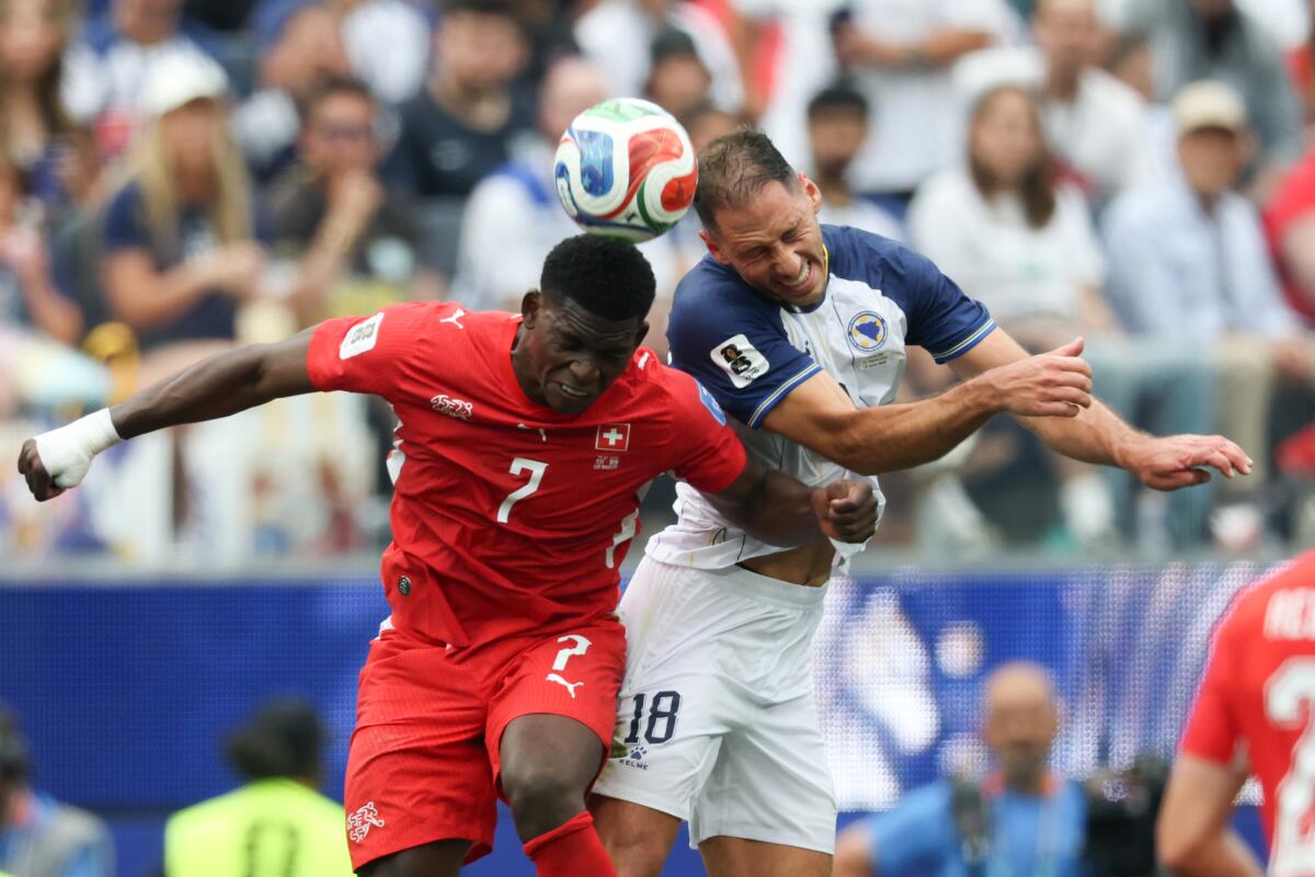 Switzerland forward Breel Embolo (7) and Bosnia and Herzegovina defender Nikola Katic (18) 