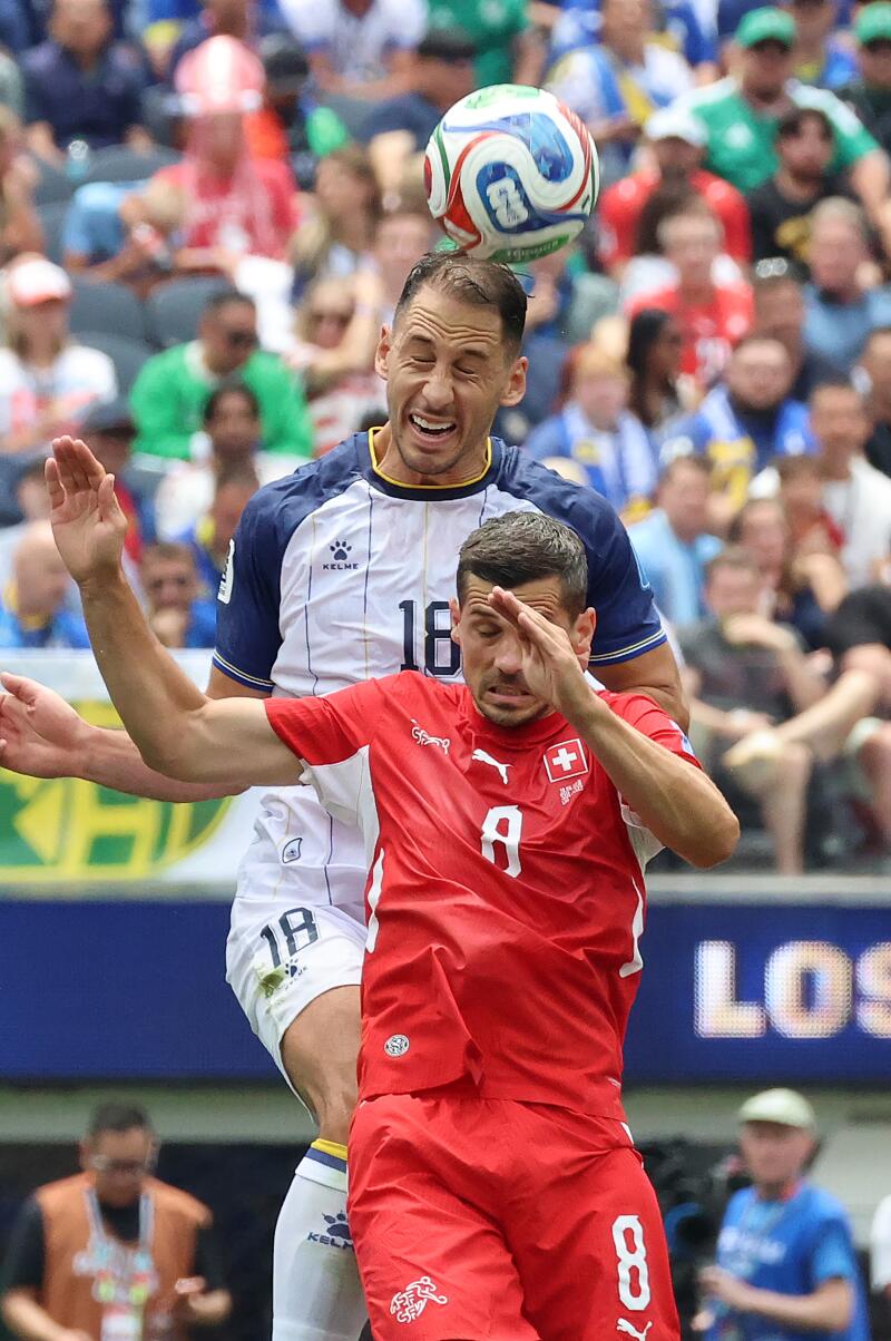 Bosnia and Herzegovina defender Nikola Katic (18), back, and Switzerland midfielder Remo Freuler (8)