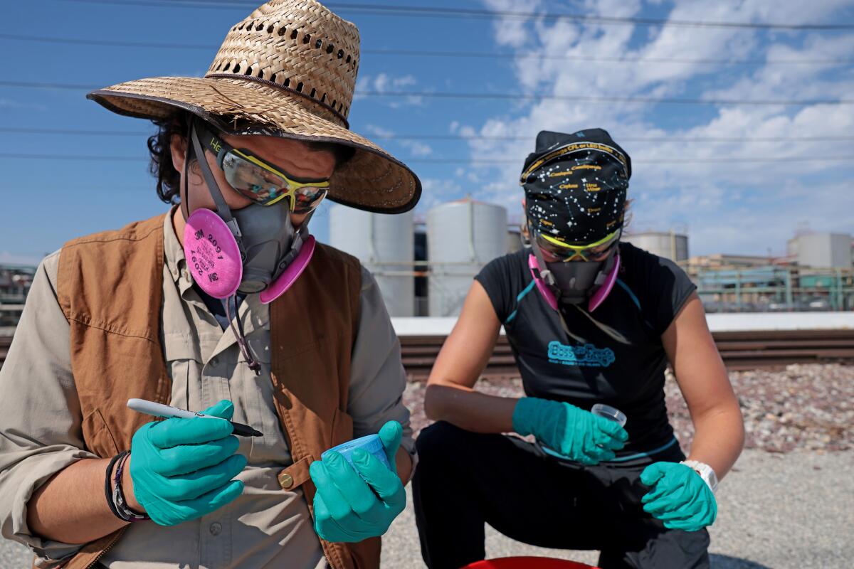 Emmanuel Carrera Ruedas, left, and Casey Cooper prep containers to take water samples from the L.A. River.
