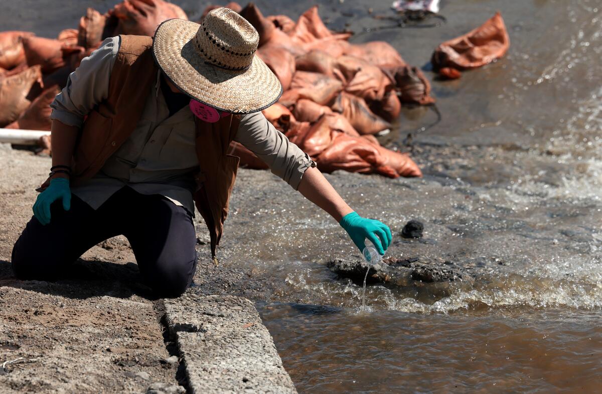 Emmanuel Carrera Ruedas takes a water sample.