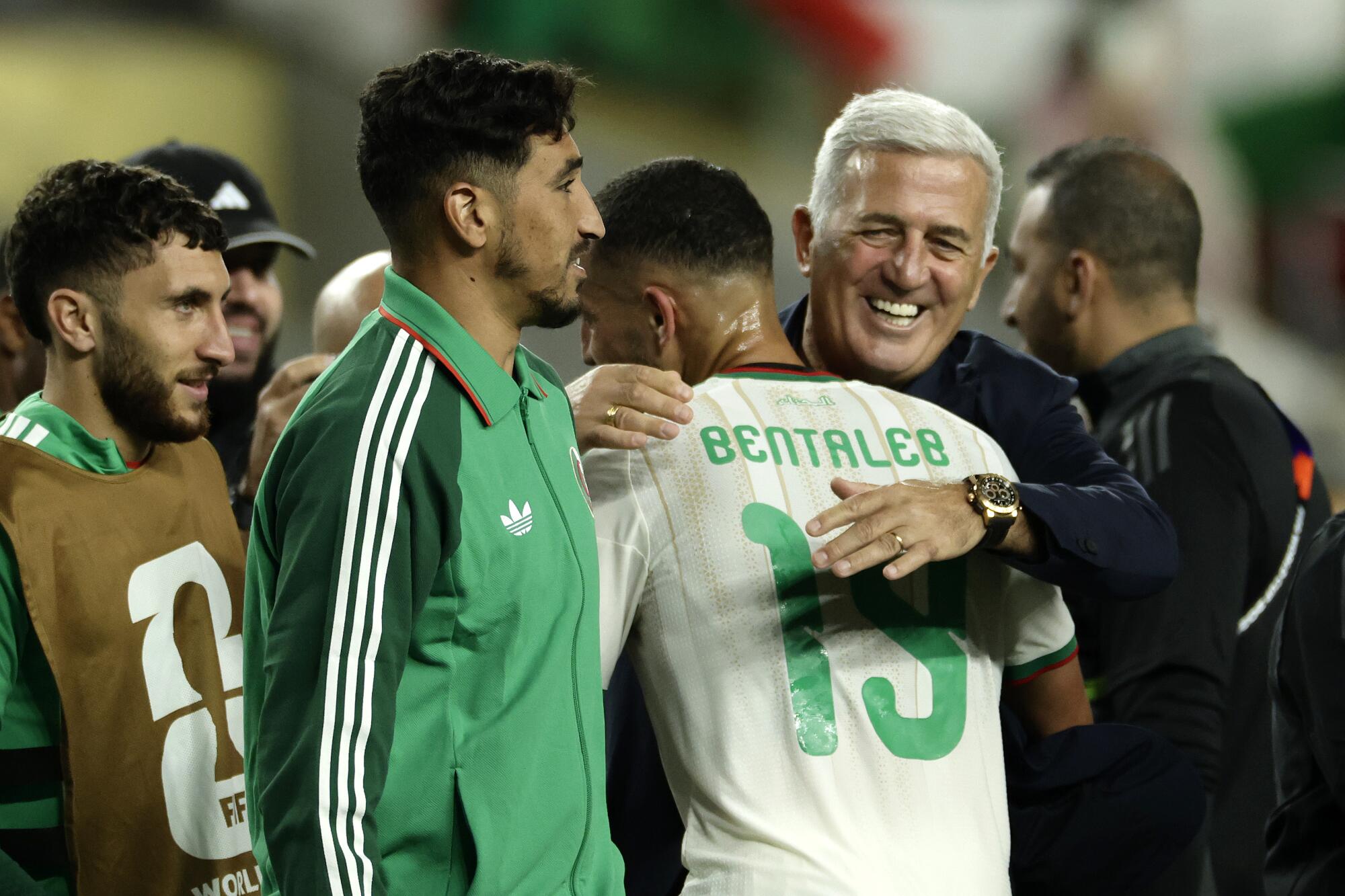 Algeria coach Vladimir Petkovic hugs midfielder Nabil Bentaleb after a win over Jordan on June 22.