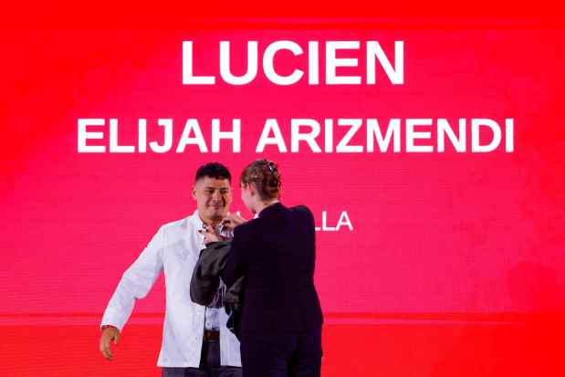Elijah Arizmendi, leader of Lucien restaurant in La Jolla, dons a white jacket upon being awarded a Michelin star during a ceremony June 24 in San Diego. (Meg McLaughlin / The San Diego Union-Tribune)