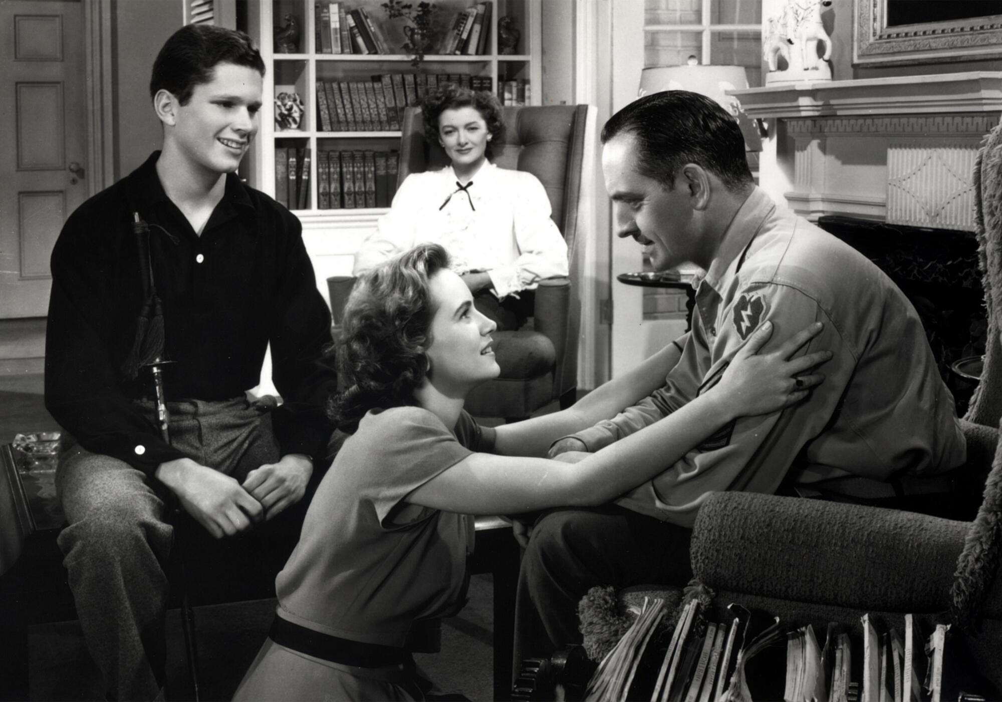 A family welcomes home a war veteran in uniform.