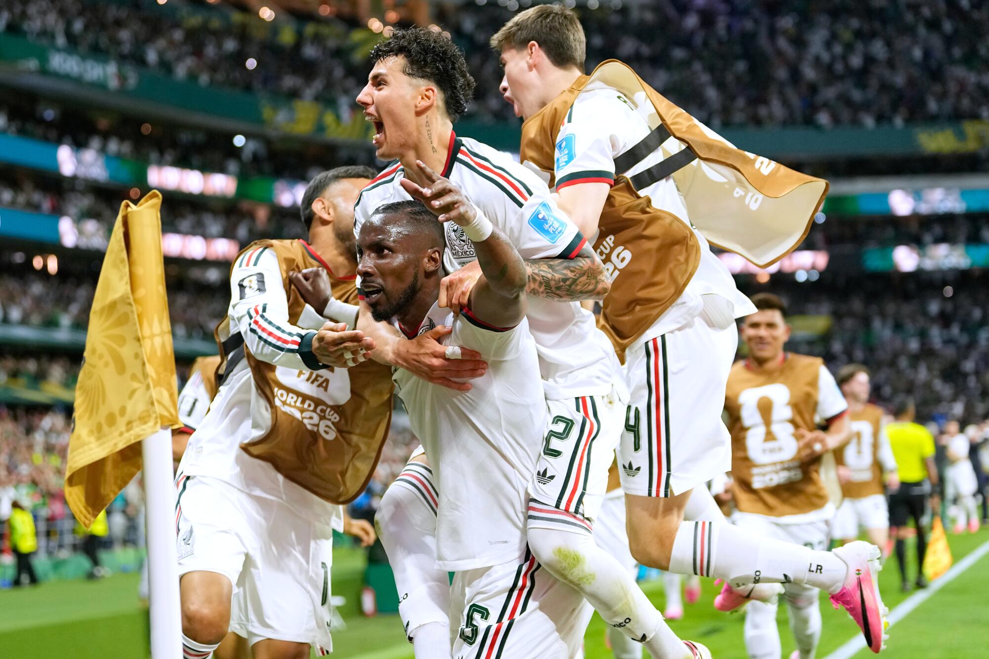 Mexico's Julián Quiñones, center, celebrates with teammates after scoring during a win over Czechia at the World Cup.