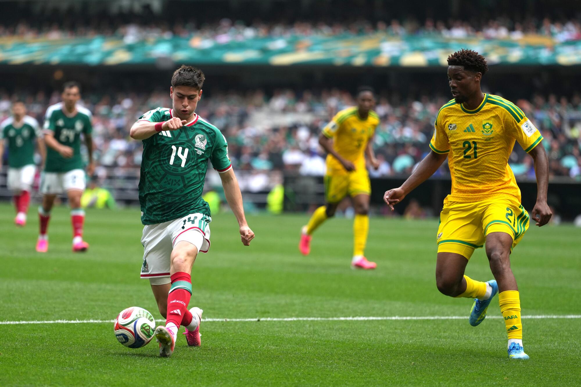 Mexico's Armando González controls the ball in front of South Africa's Ime Okon during on a World Cup match on June 11.