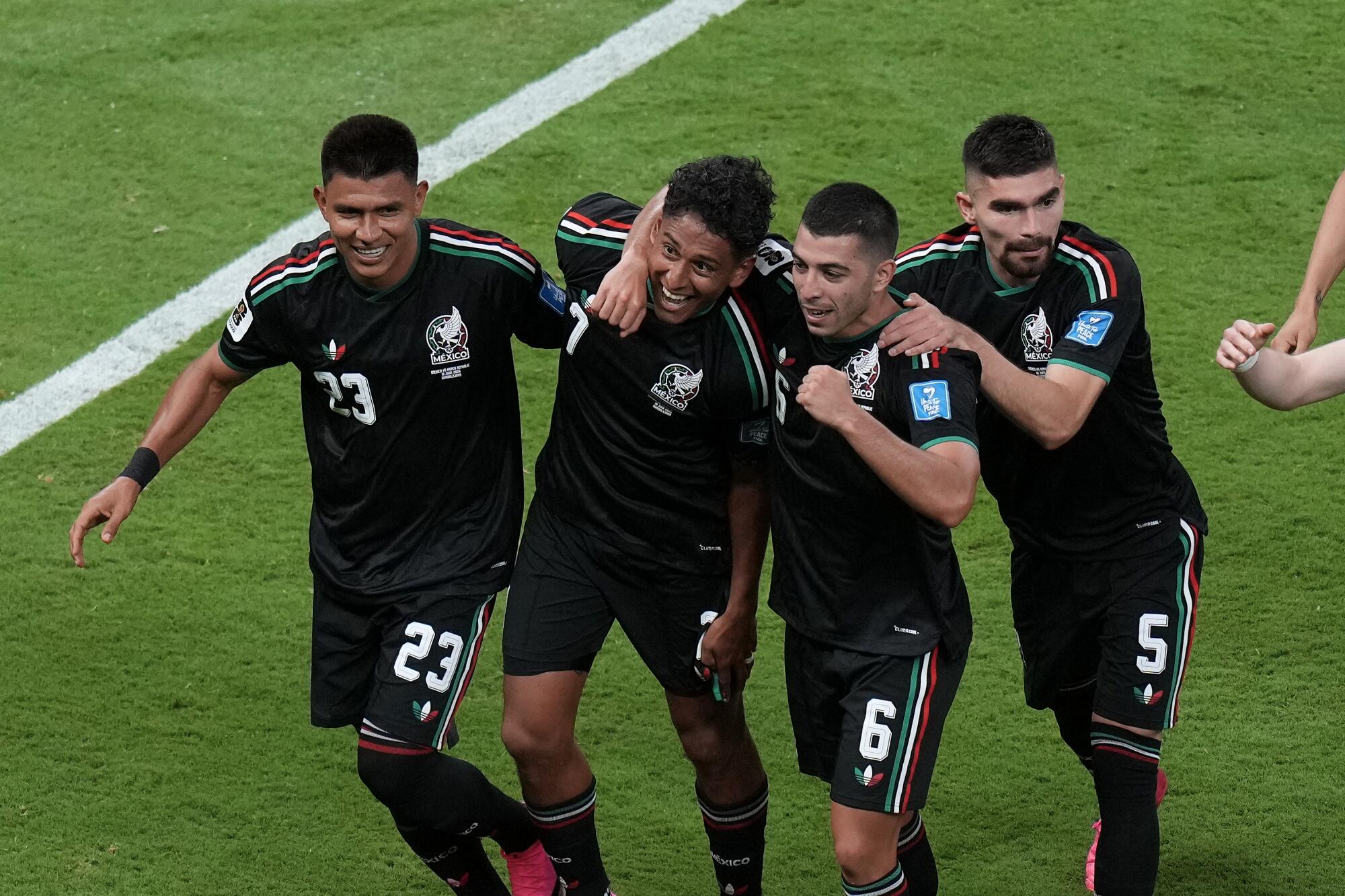 Mexico's Luis Romo celebrates with Jesus Gallardo, Erik Lira and Johan Vasquez after scoring against South Korea.