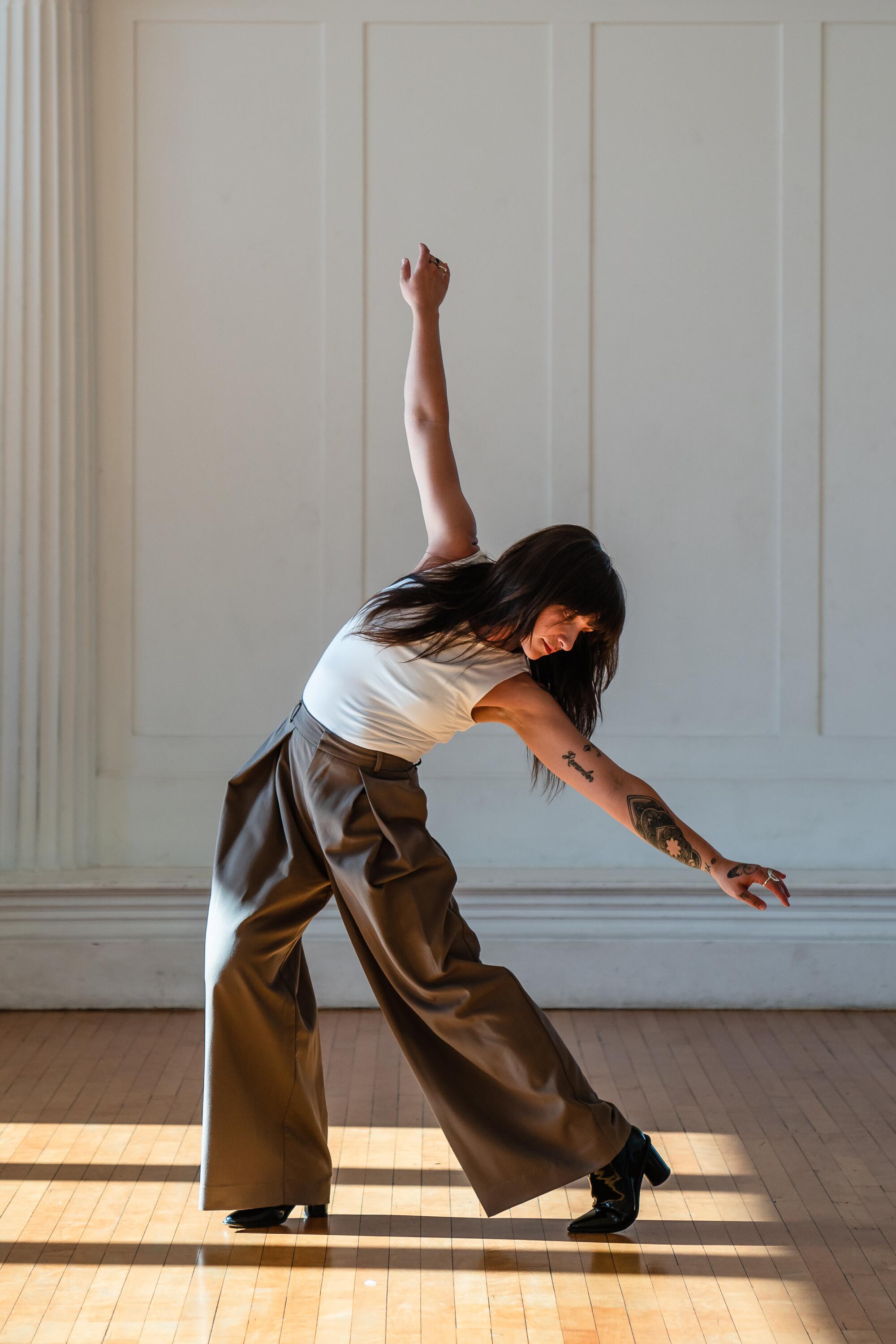 Dani Burd dances in a studio. 