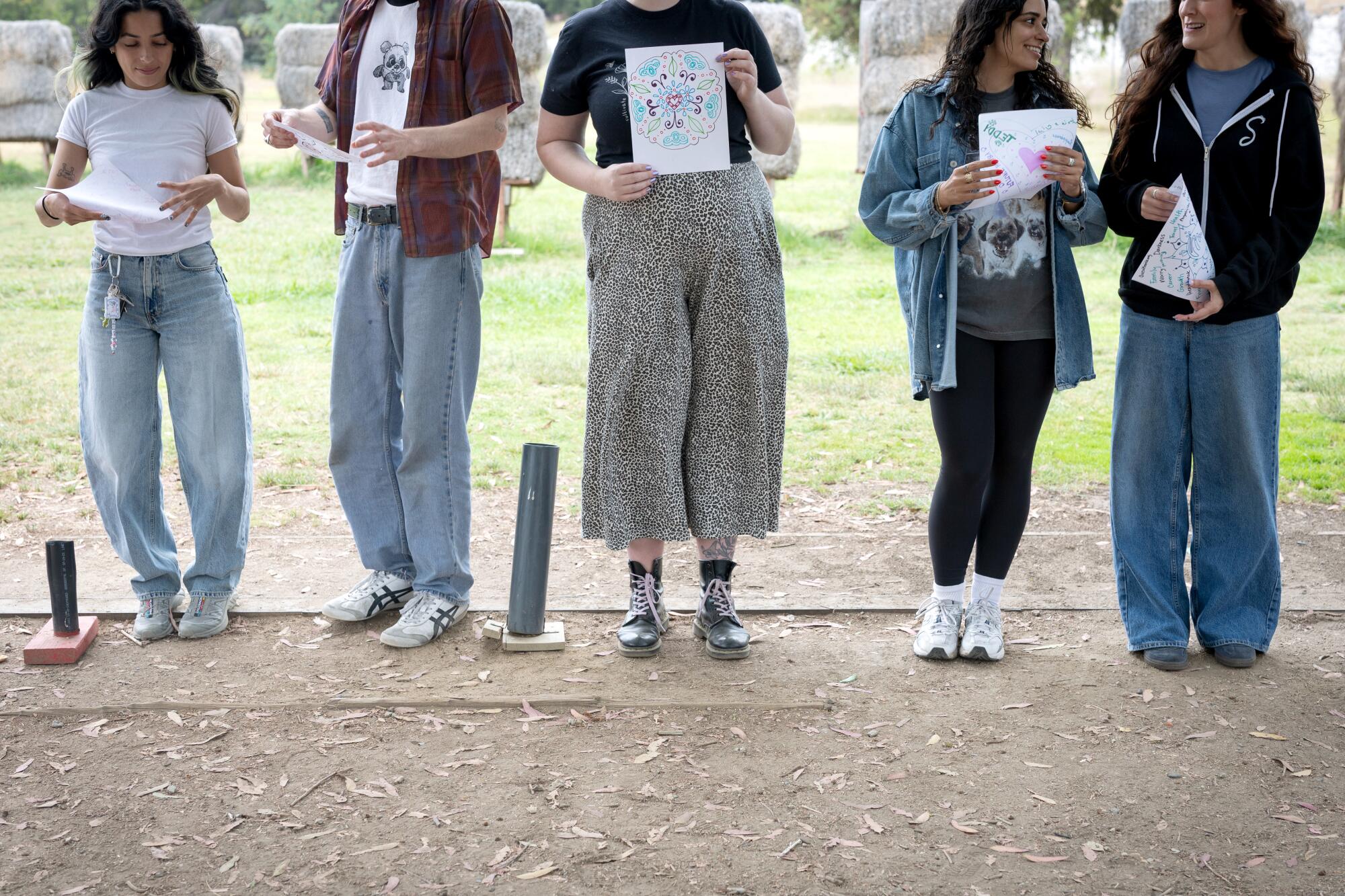 Attendees hold up their targets during a Mindful Archery class.