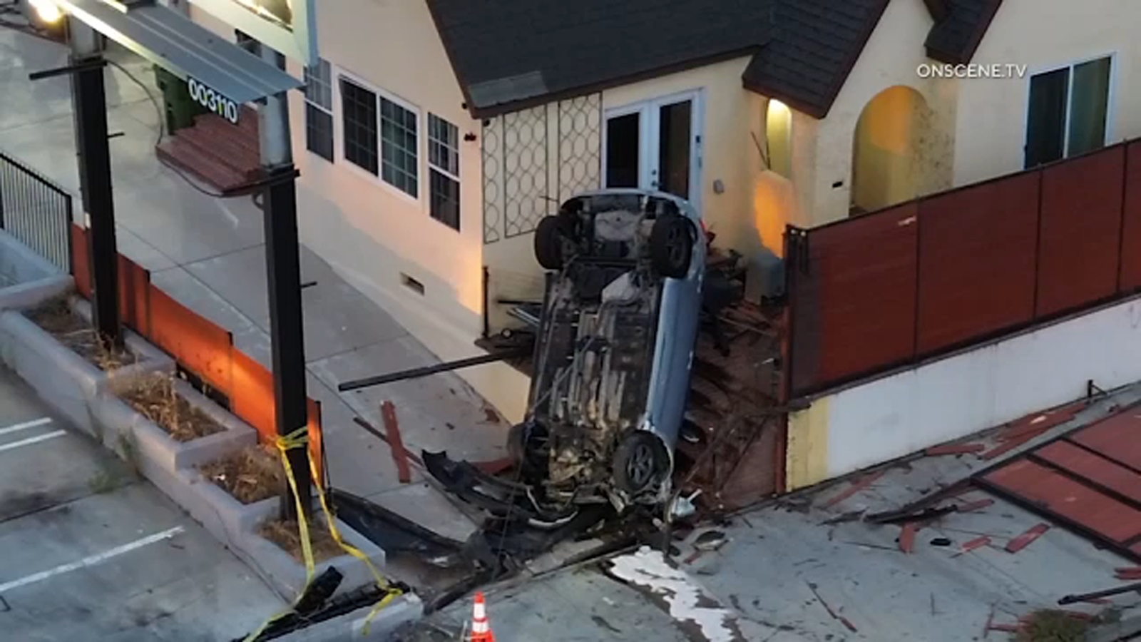 Driver crashes into Wilmington home, flipping vehicle and leaving it standing upright