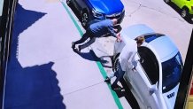 This is a screen shot taken from a security camera video. It appears to show an elderly man trip and fall on a protruding metal base left unprotected after a parking meter was removed, June 26, 2026.