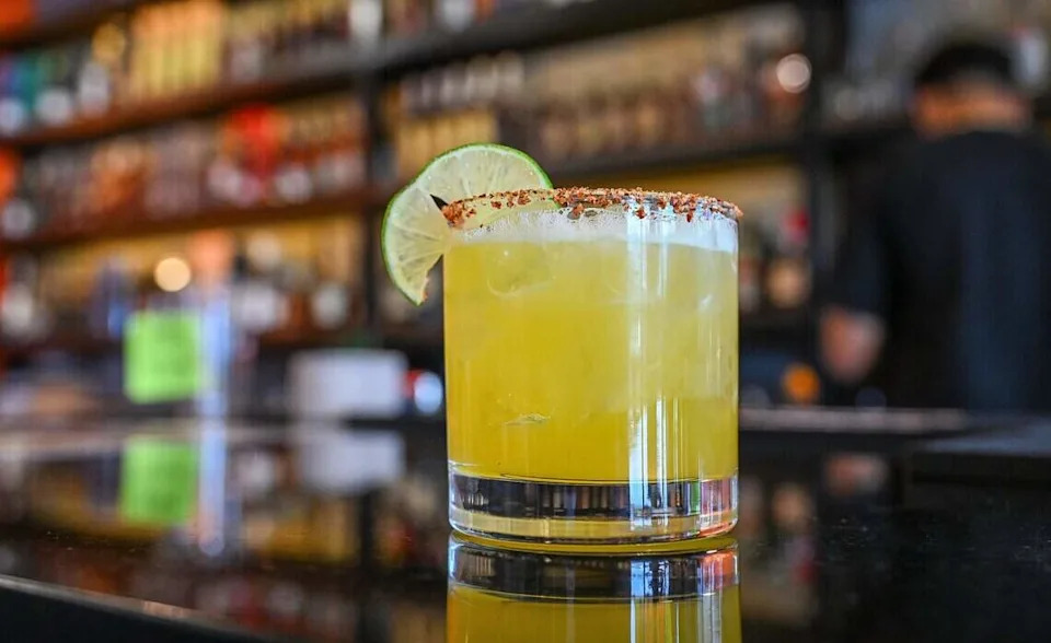 A Sunnyside Spice specialty cocktail, described as sweet, tangy and spicy, is ready to drink at The Curry Pizza Company's newest location on Fowler south of Belmont in southeast Fresno on Tuesday, June 9, 2026. This one has a full bar.
