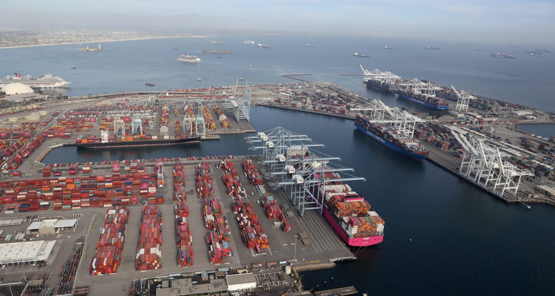 Shipping containers are unloaded from ships at a container terminal at the Port of Long Beach-Port of Los Angeles complex, amid the coronavirus disease