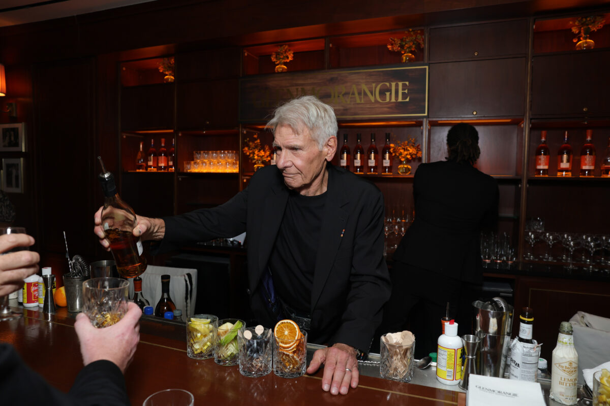 Harrison Ford pouring Whisky behind the bar at the launch of his limited-edition whisky with Glenmorangie at Sunset Tower Hotel.
