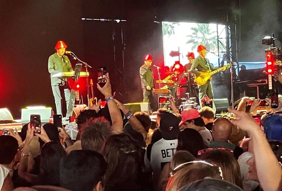 Devo performs at the Coachella Valley Music & Arts Festival wearing their signature red hats known as "Power Domes" on Friday, April 10, 2026.