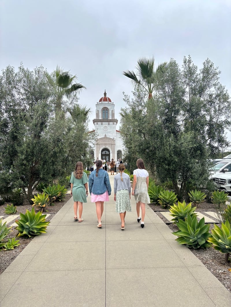 Young women walk on the grounds of the Yorba Linda California Temple during the open house in Yorba Linda, California, on Saturday, May 2, 2026.