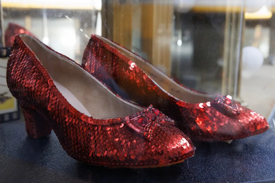 Pair of red sequined high heels with jeweled bows on the toes at History For Hire prop house. Jonathan Alcorn for CA Post